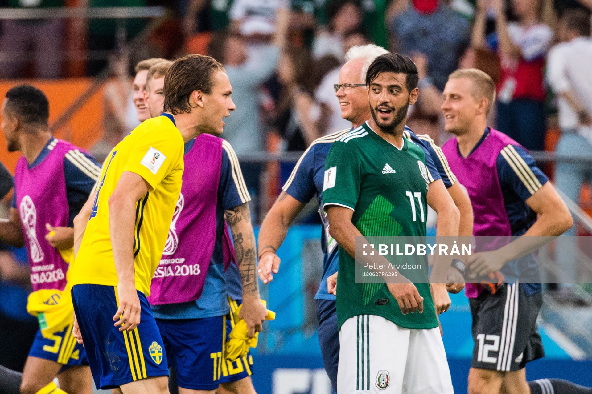 Albin Ekdal of Sweden heckle Carlos Vela of Mexico