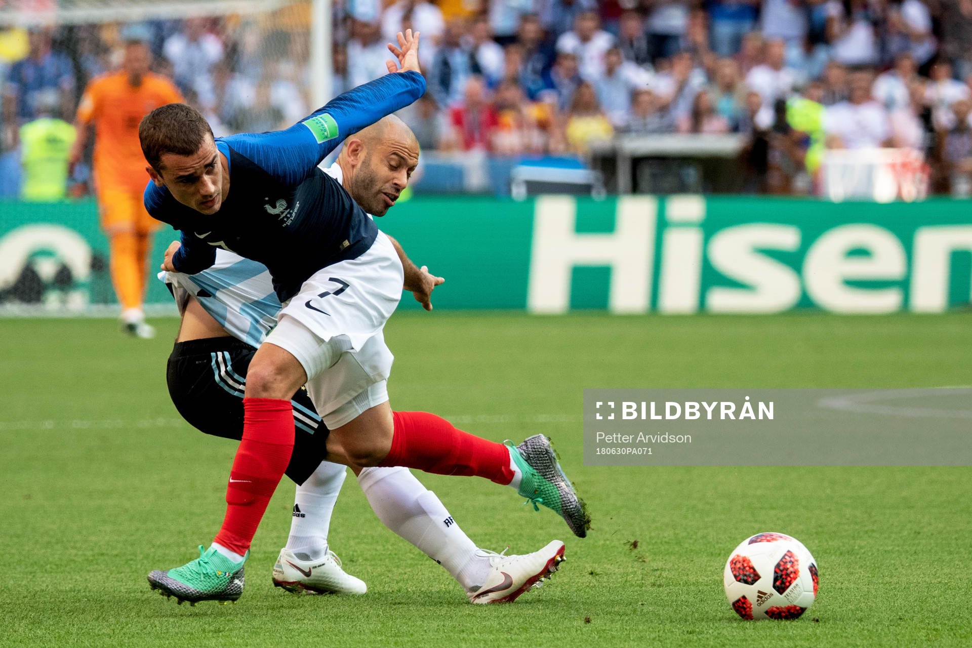 Antoine Griezmann of France and Javier Mascherano of