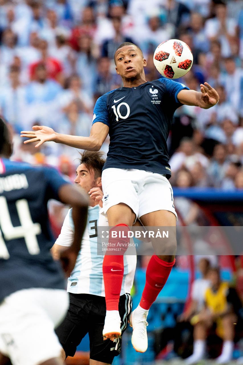 Kylian Mbappe of France and Nicolas Tagliafico of Argentina