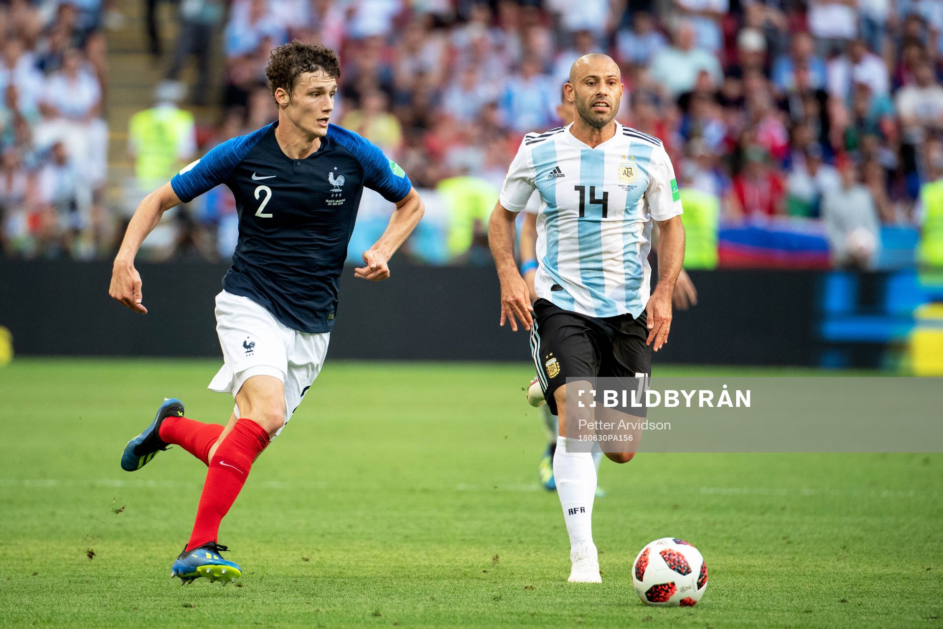 Benjamin Pavard of France and Javier Mascherano of Argentina