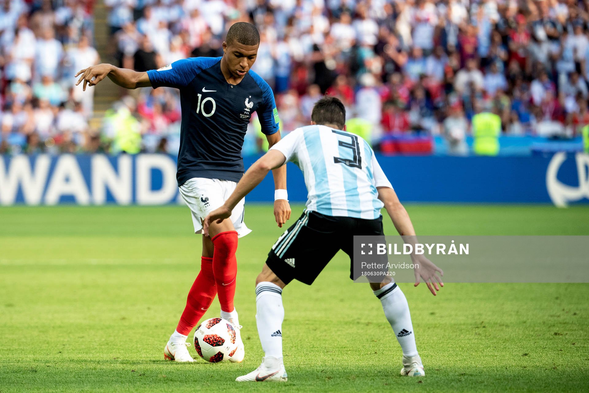 Kylian Mbappe of France and Nicolas Tagliafico of Argentina