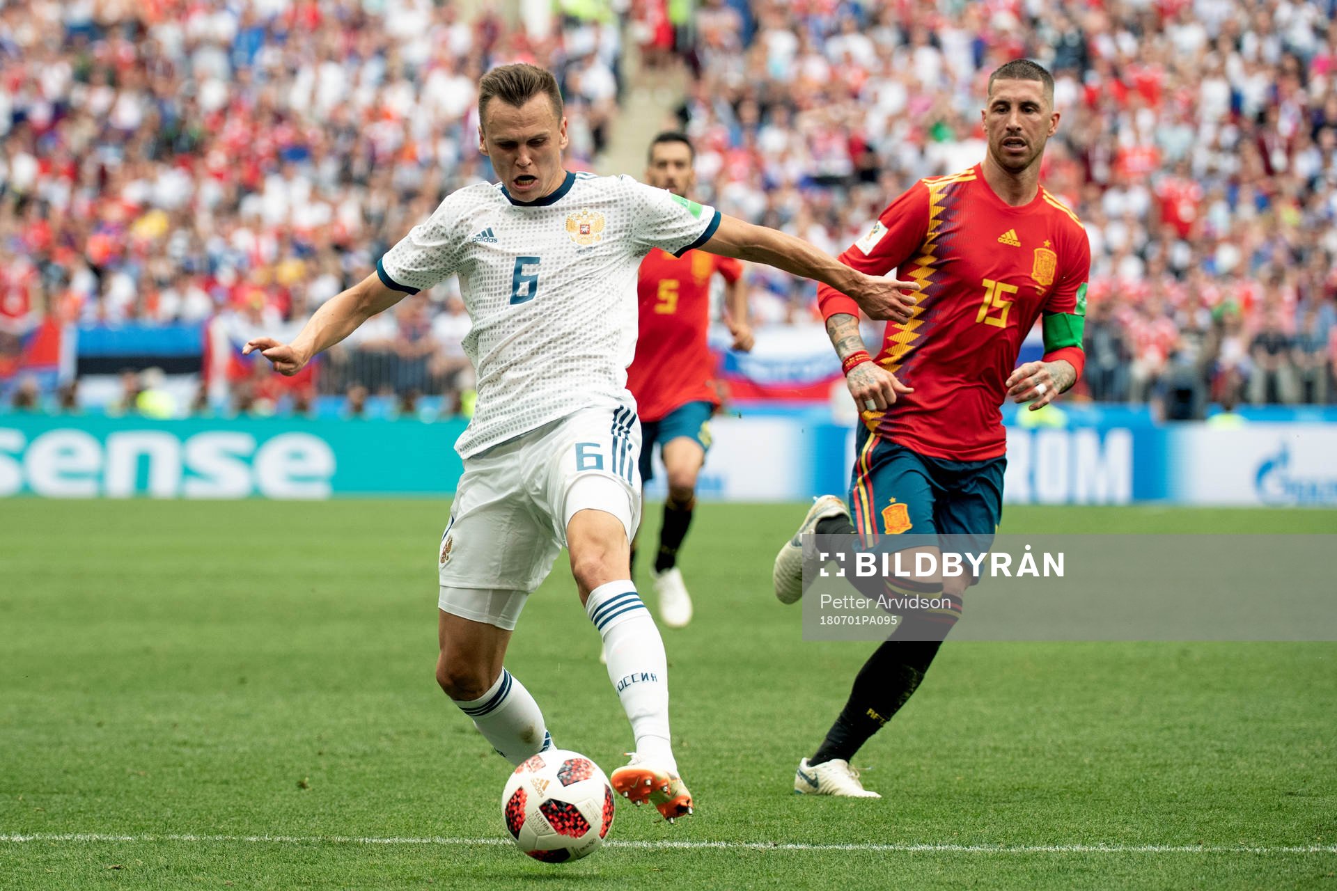 Denis Cheryshev of Russia and Sergio Ramos of Spain