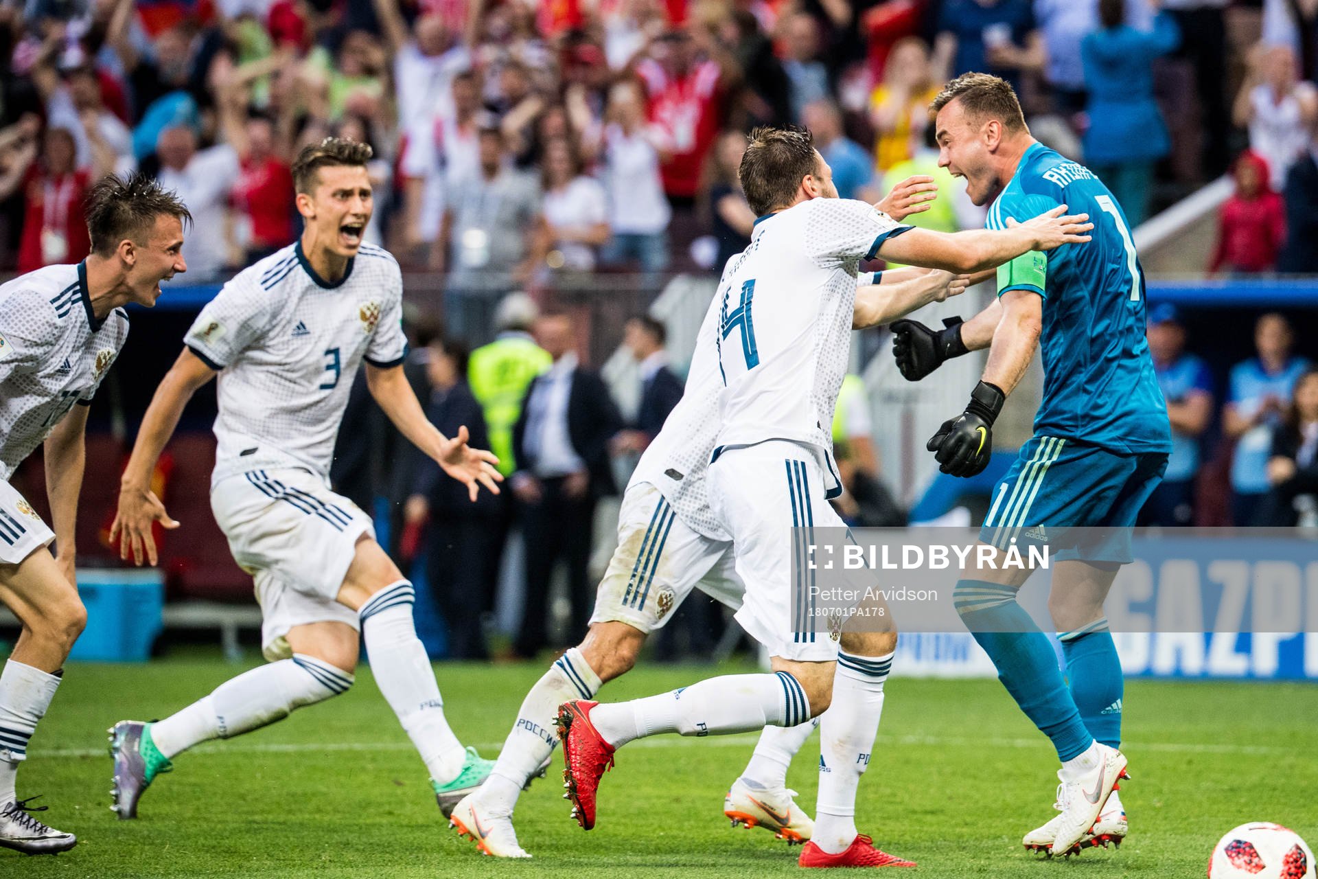 Goalkeeper Igor Akinfeev celebrates with team mates after the penalty shoot-out during the FIFA World Cup round of 16 match between Spain and Russia on July 1, 2018 in Moscow.
