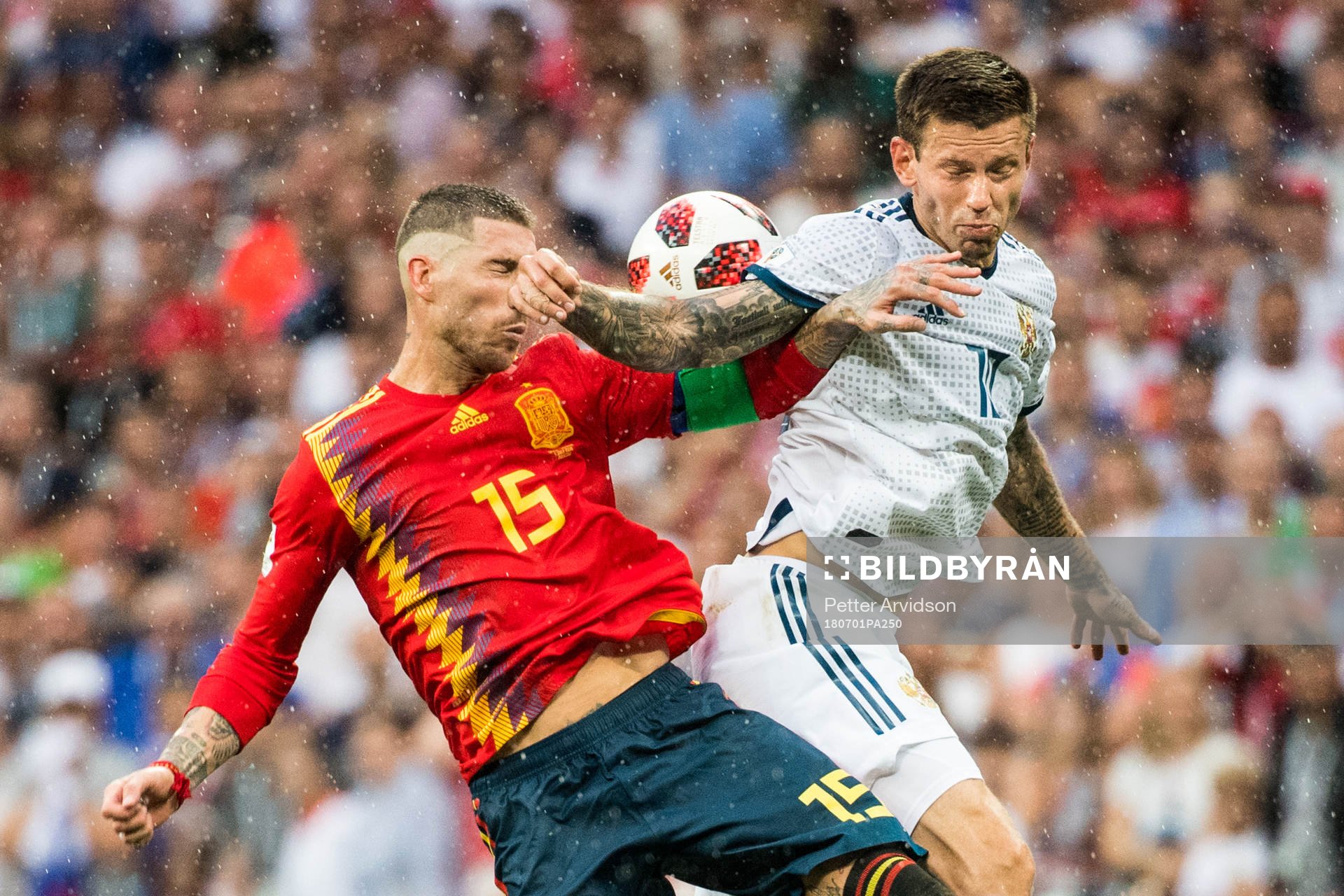 Sergio Ramos of Spain in action with Fedor Smolov of Russia