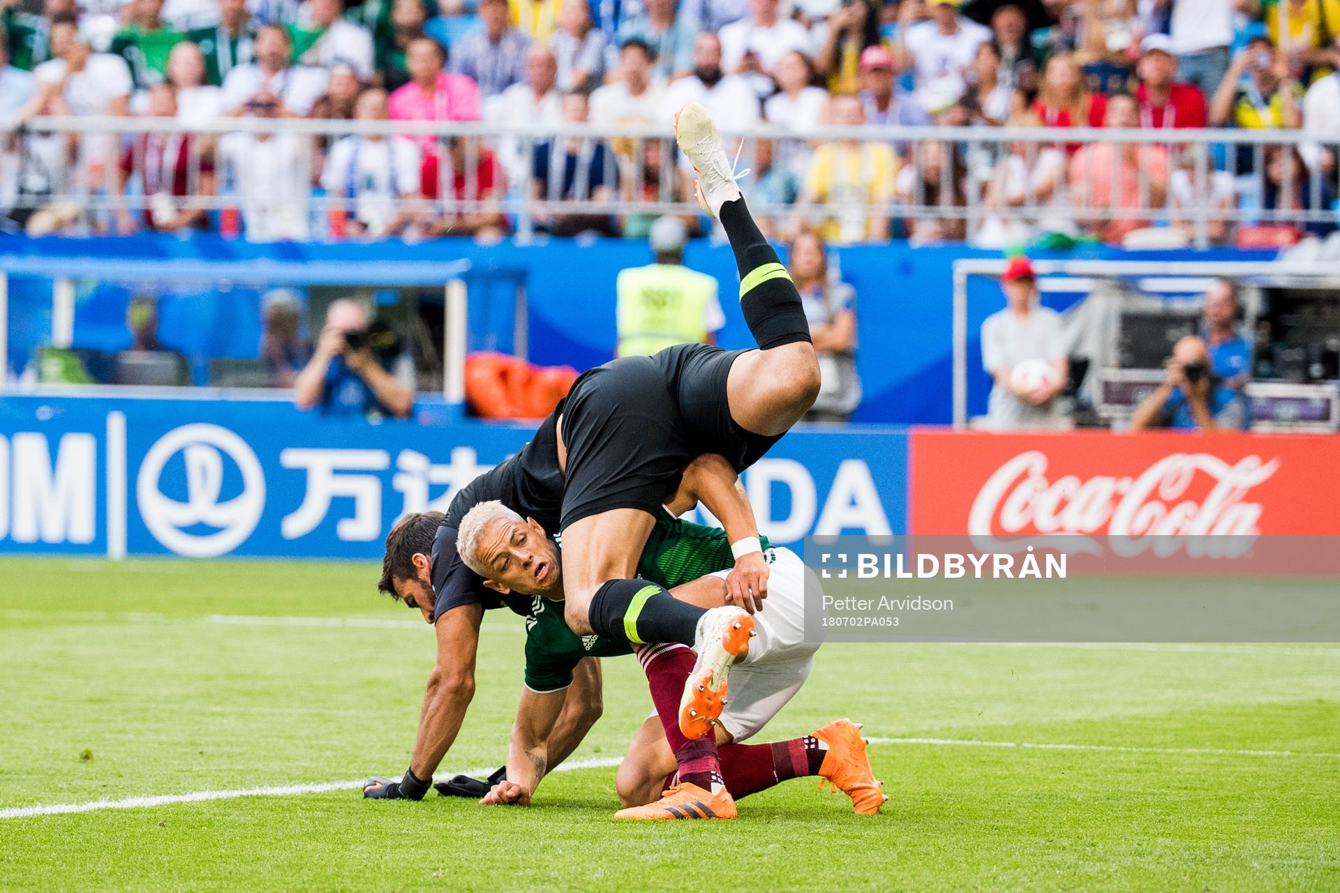 Goalkeeper Alisson of Brazil and Javier Hernandez of Mexico