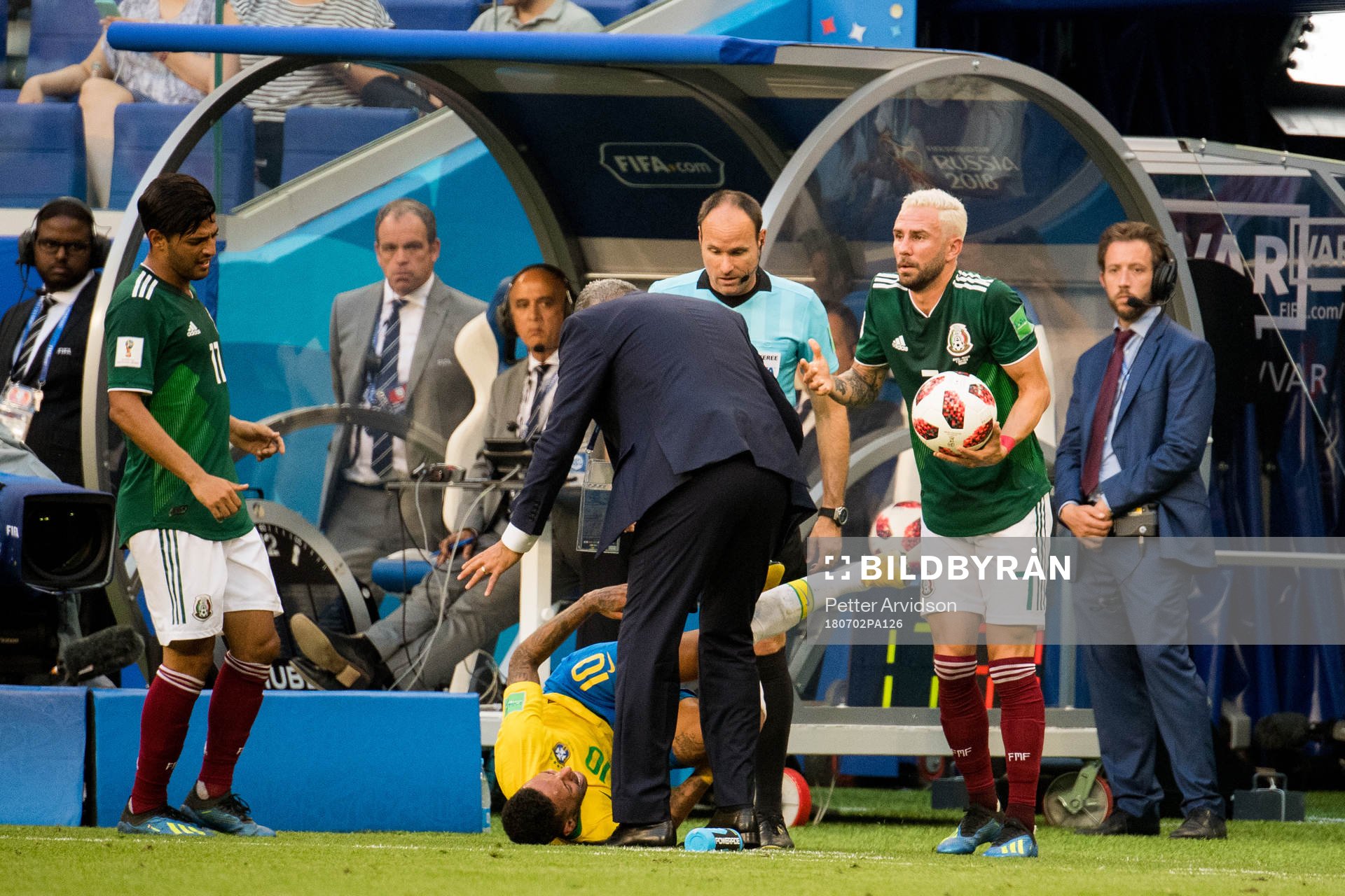 Neymar of Brazil with an injury and Miguel Layun of Mexico
