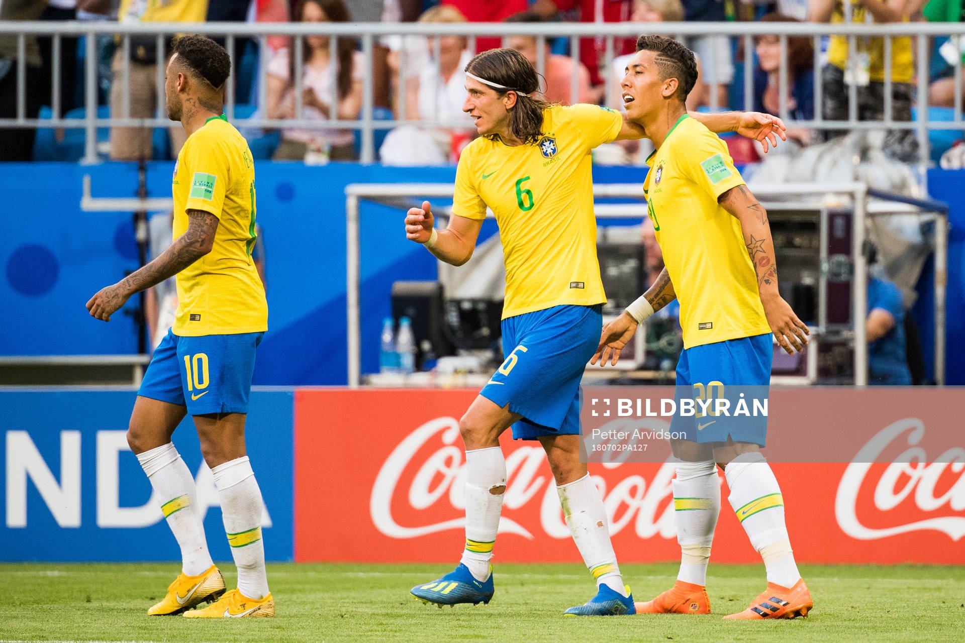 Roberto Firmino of Brazil celebrates with Filipe Luis of