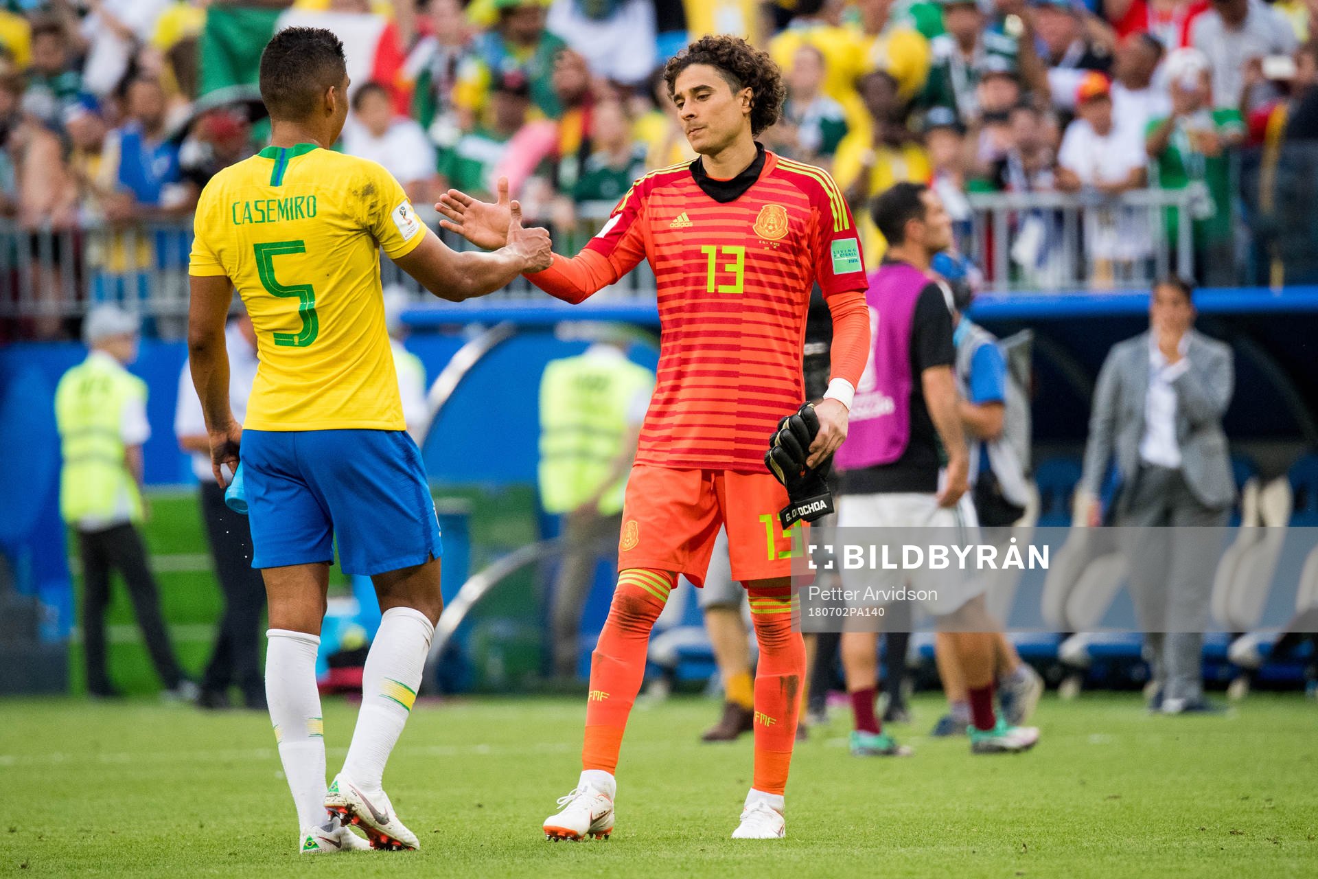 Casemiro of Brazil and goalkeeper Guillermo Ochoa of Mexico