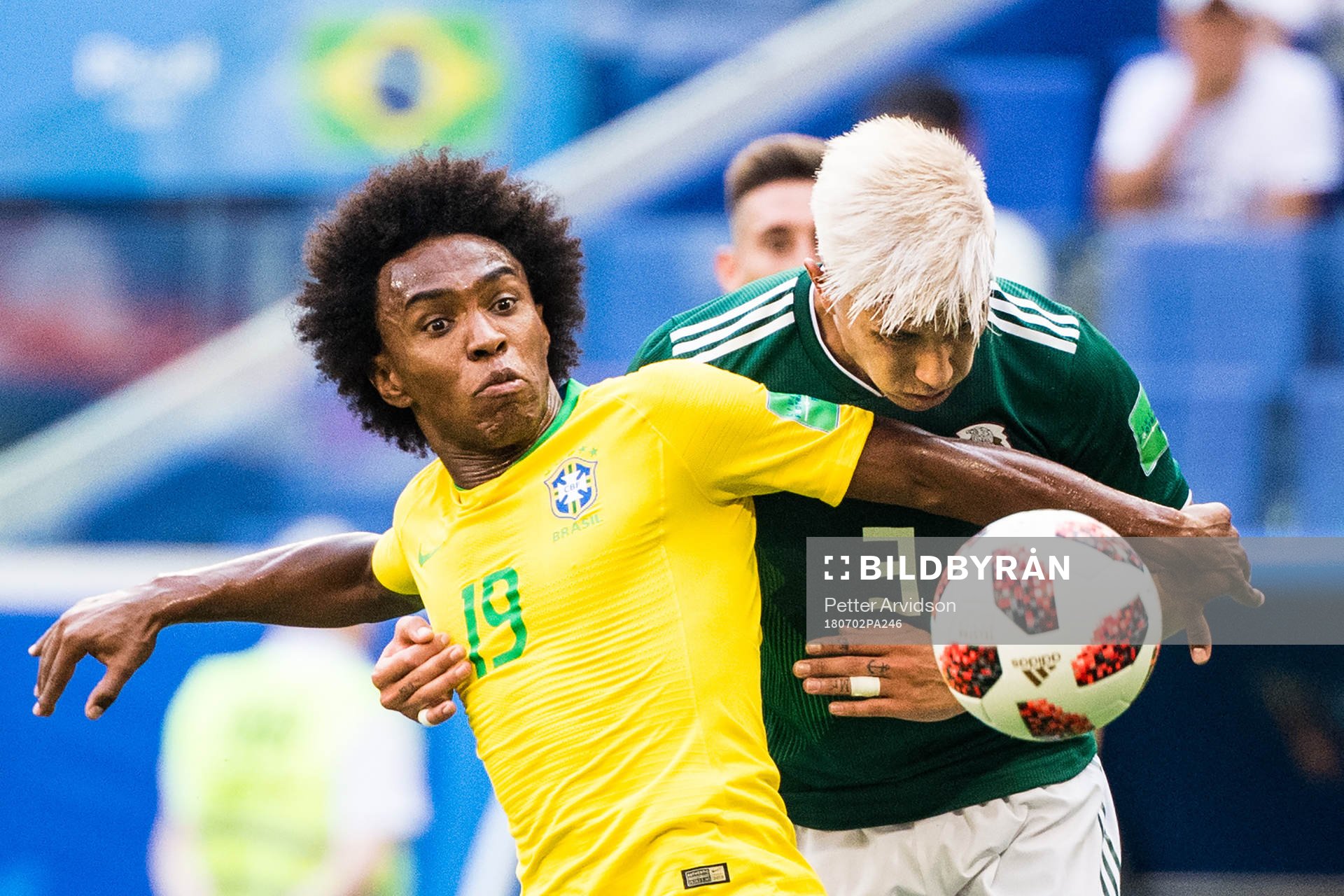 Willian of Brazil in action with Carlos Salcedo of Mexico