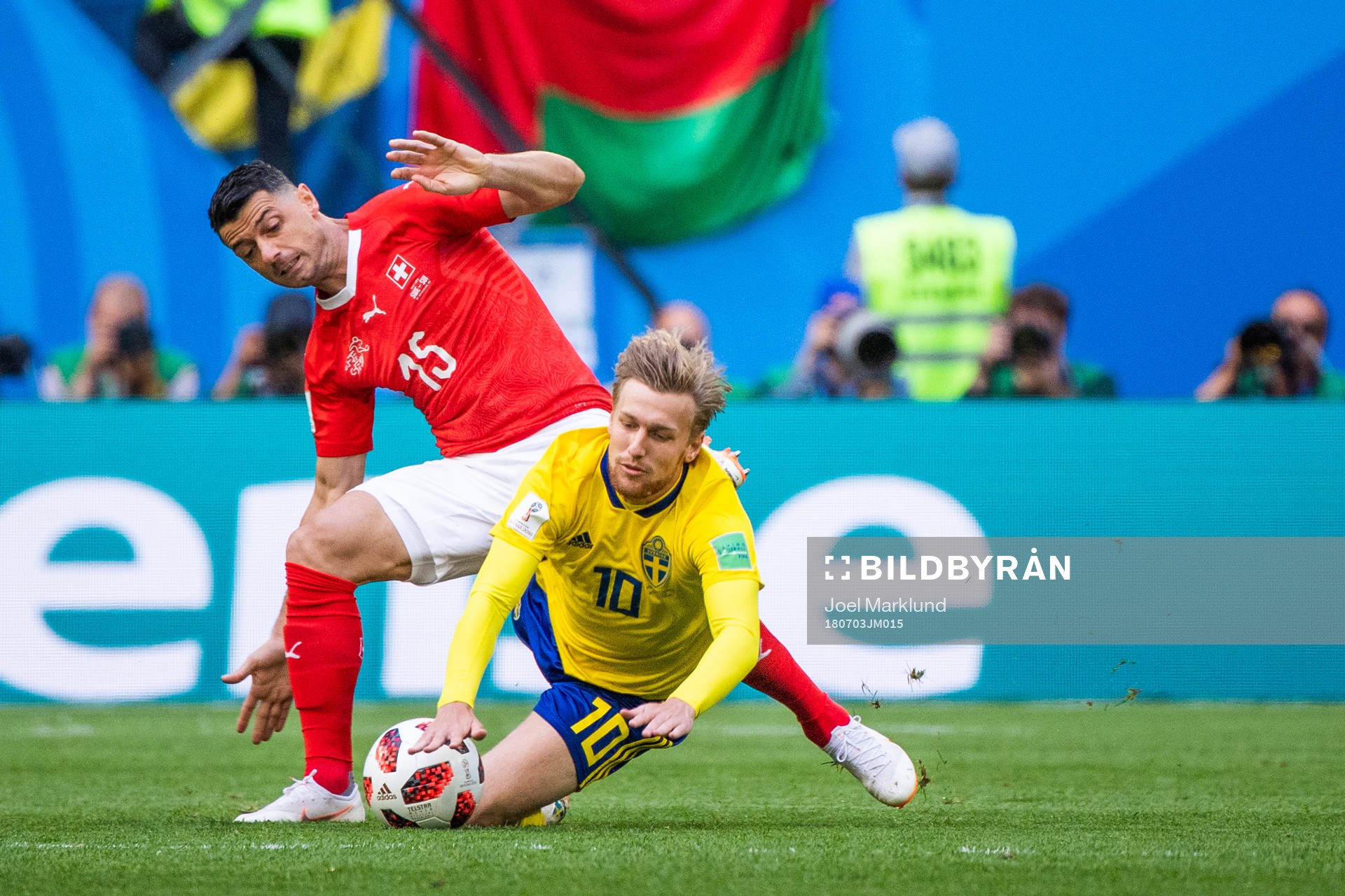 Blerim Dzemaili competes for the ball with Emil Forsberg of