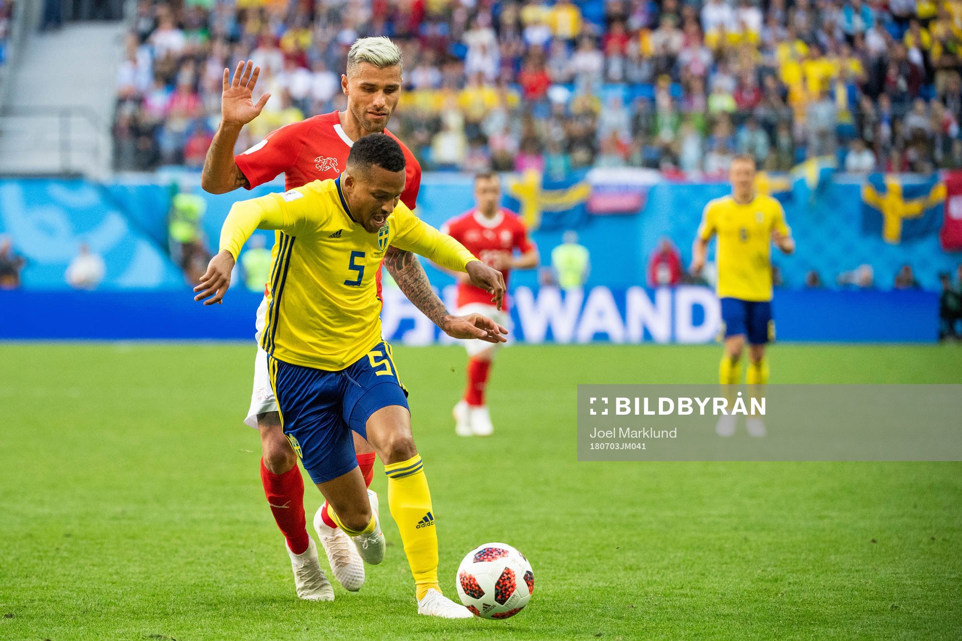 Martin Olsson of Sweden competes for the ball with Valon