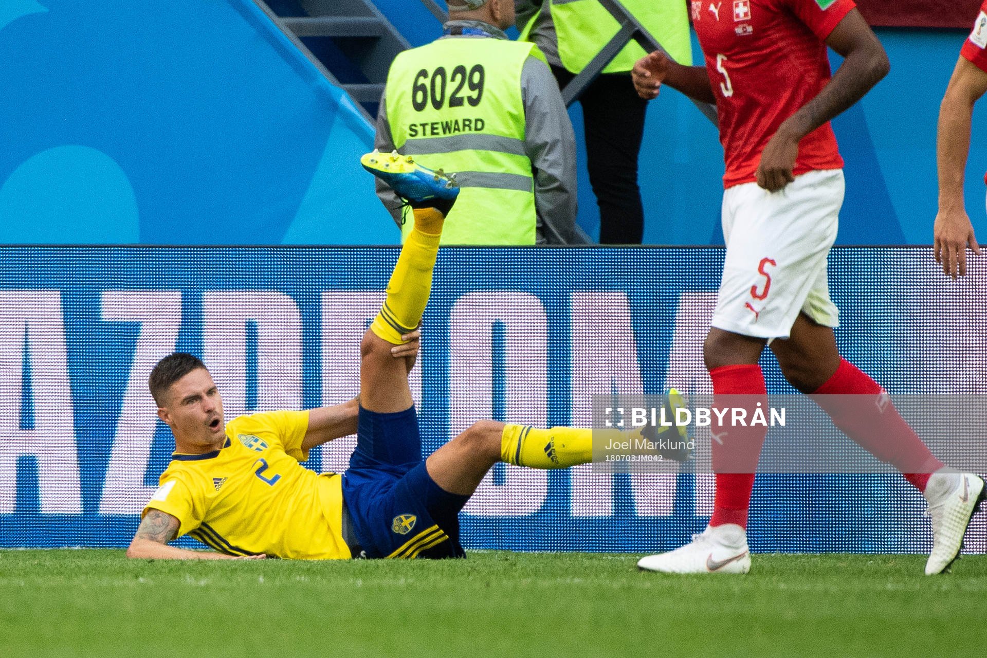 Mikael Lustig of Sweden lies down and reaches for his leg