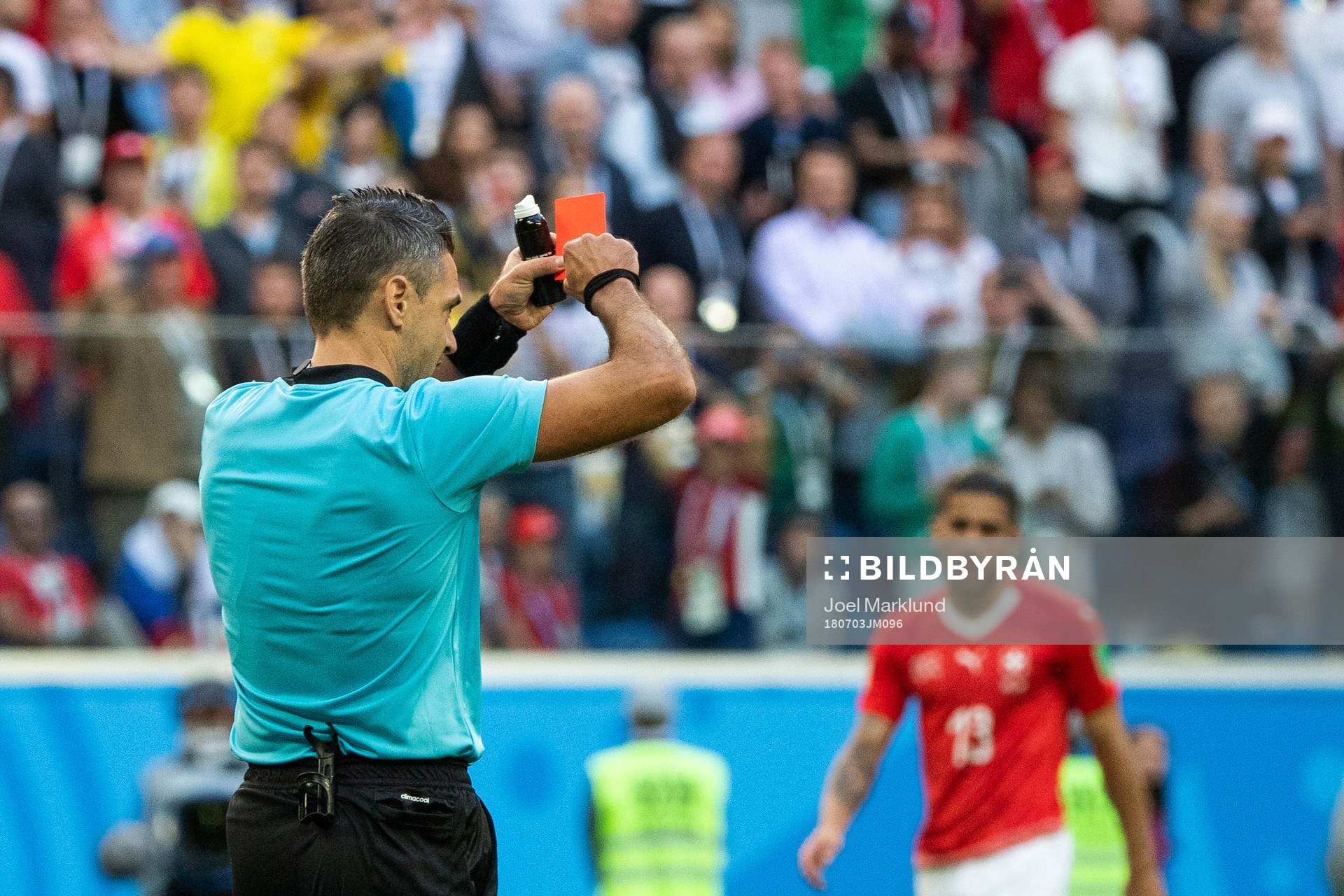 Referee Damir Skomina gives a reda card to Michael Lang of Switzerland (not pictured) during the FIFA World Cup round of 16 match between Sweden and Switzerland on July 3, 2018 in St Petersburg.
