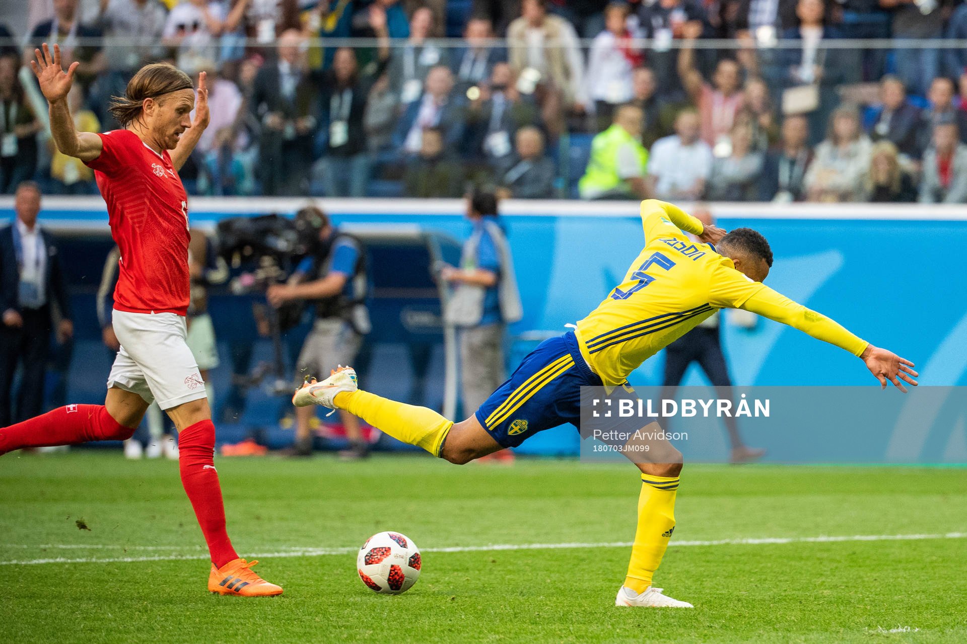 Martin Olsson falls and is awarded a penalty in a duel with Michael Lang of Switzerland during the FIFA World Cup round of 16 match between Sweden and Switzerland on July 3, 2018 in St Petersburg.