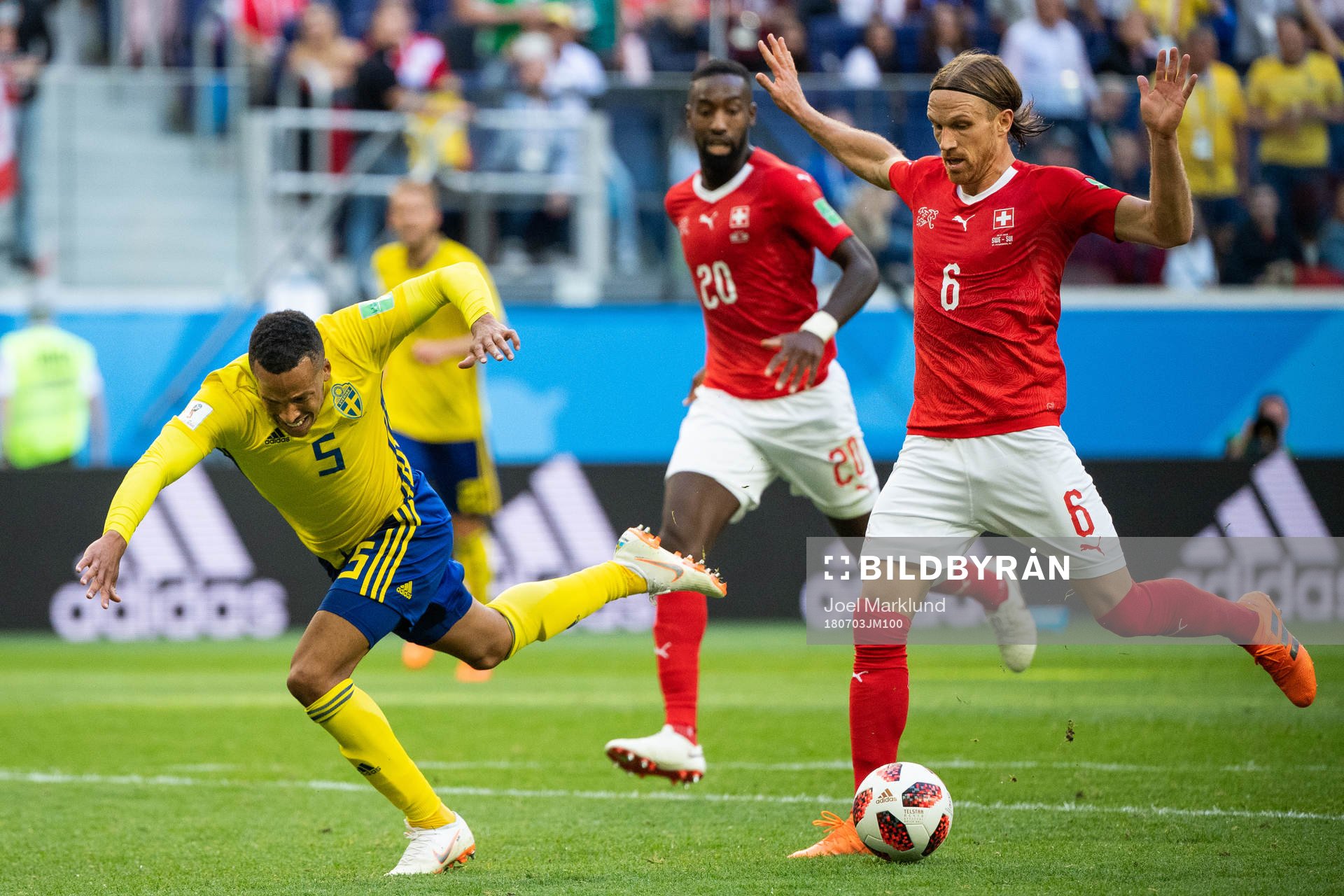 Martin Olsson of Sweden falls after a duel with Michael Lang of Switzerland during the FIFA World Cup round of 16 match between Sweden and Switzerland on July 3, 2018 in St Petersburg.