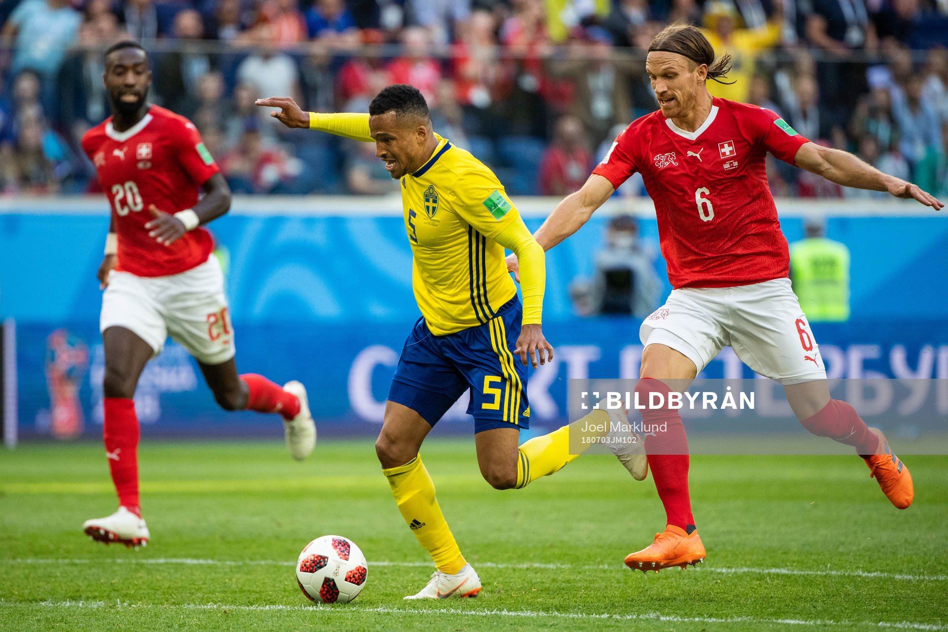 Martin Olsson of Sweden falls after a duel with Michael Lang of Switzerland during the FIFA World Cup round of 16 match between Sweden and Switzerland on July 3, 2018 in St Petersburg.