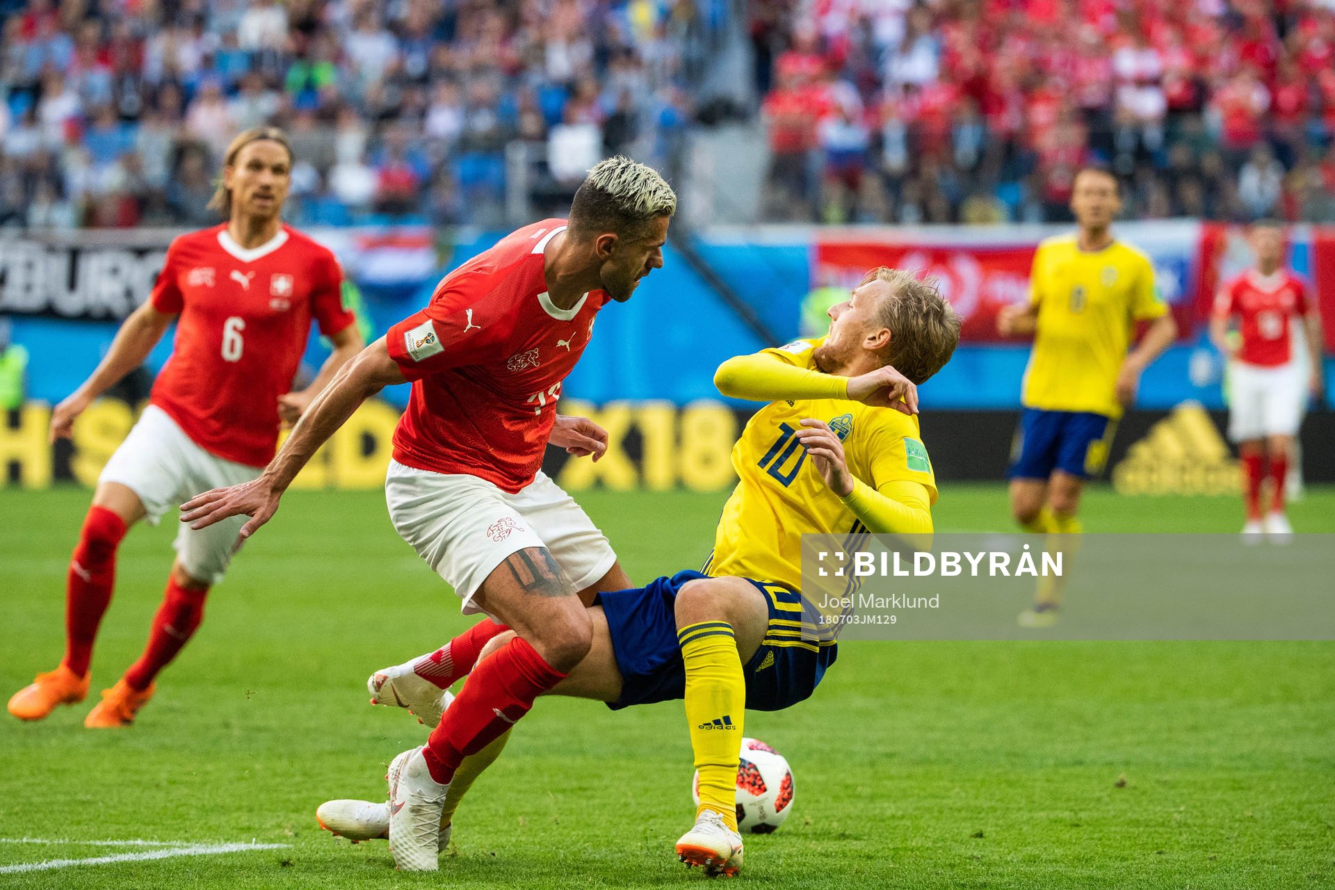 Valon Behrami of Switzerland tackles Emil Forsberg of Sweden
