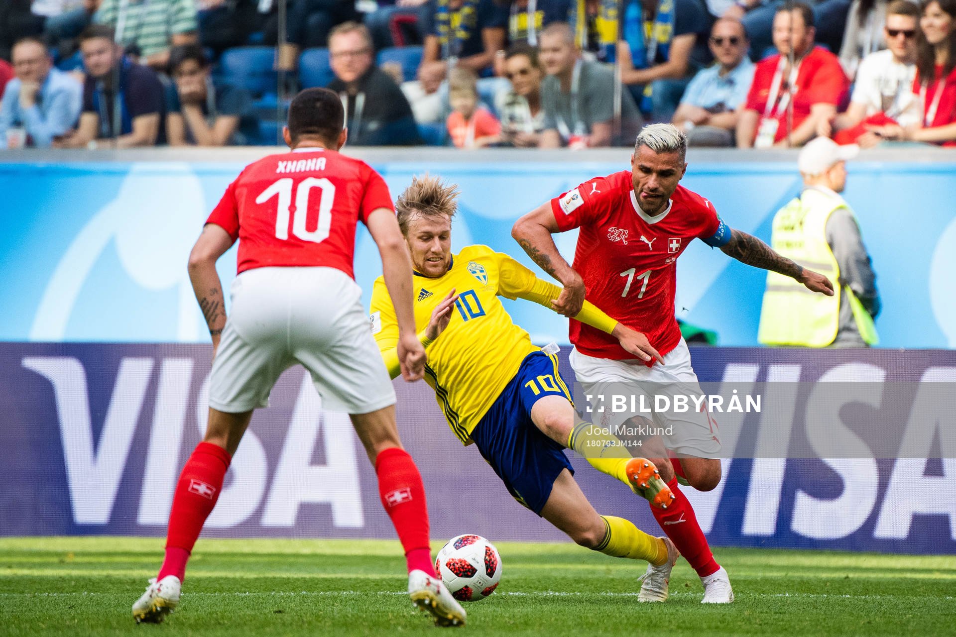 Emil Forsberg of Sweden tackled by Valon Behrami of