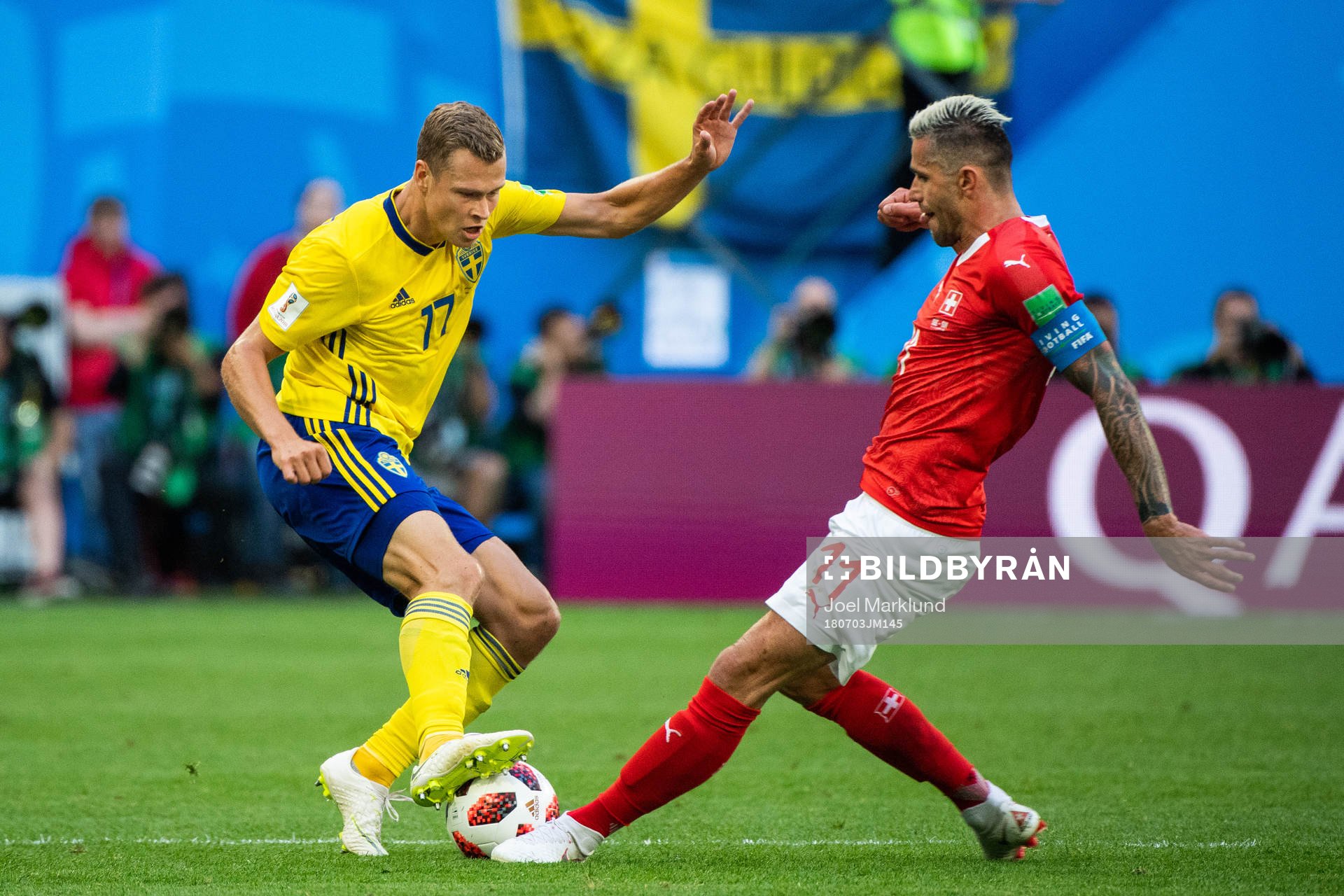 Viktor Claesson of Sweden adn Valon Behrami of Switzerland