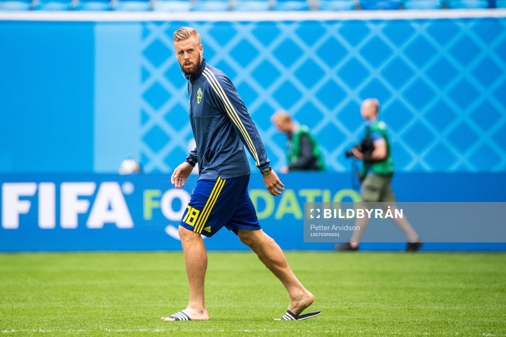 Pontus Jansson of Sweden inspects the pitch prior to the