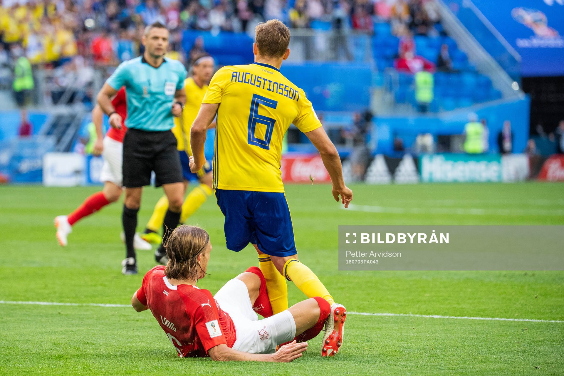Michael Lang of Switzerland tackles Ludwig Augustinsson of