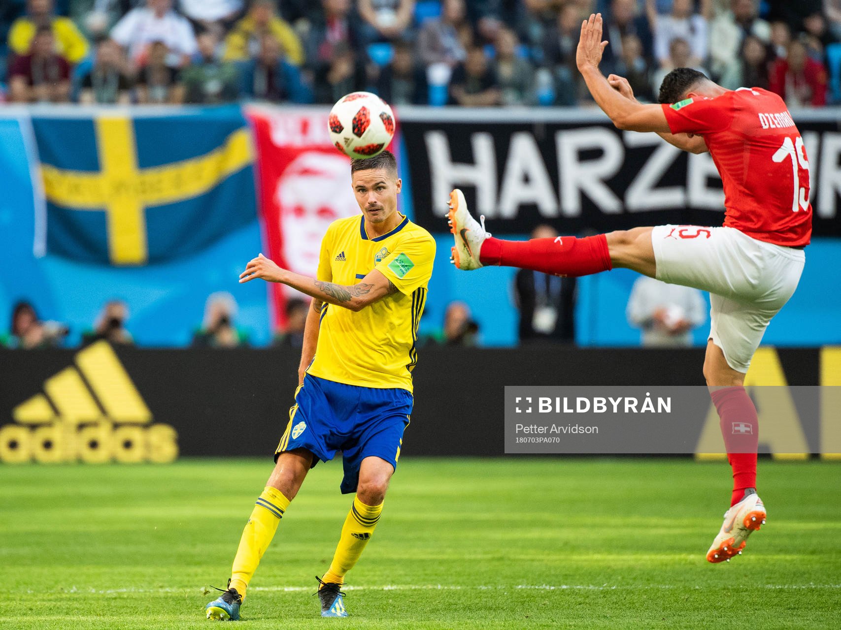 Mikael Lustig of Sweden and Blerim Dzemaili of Switzerland