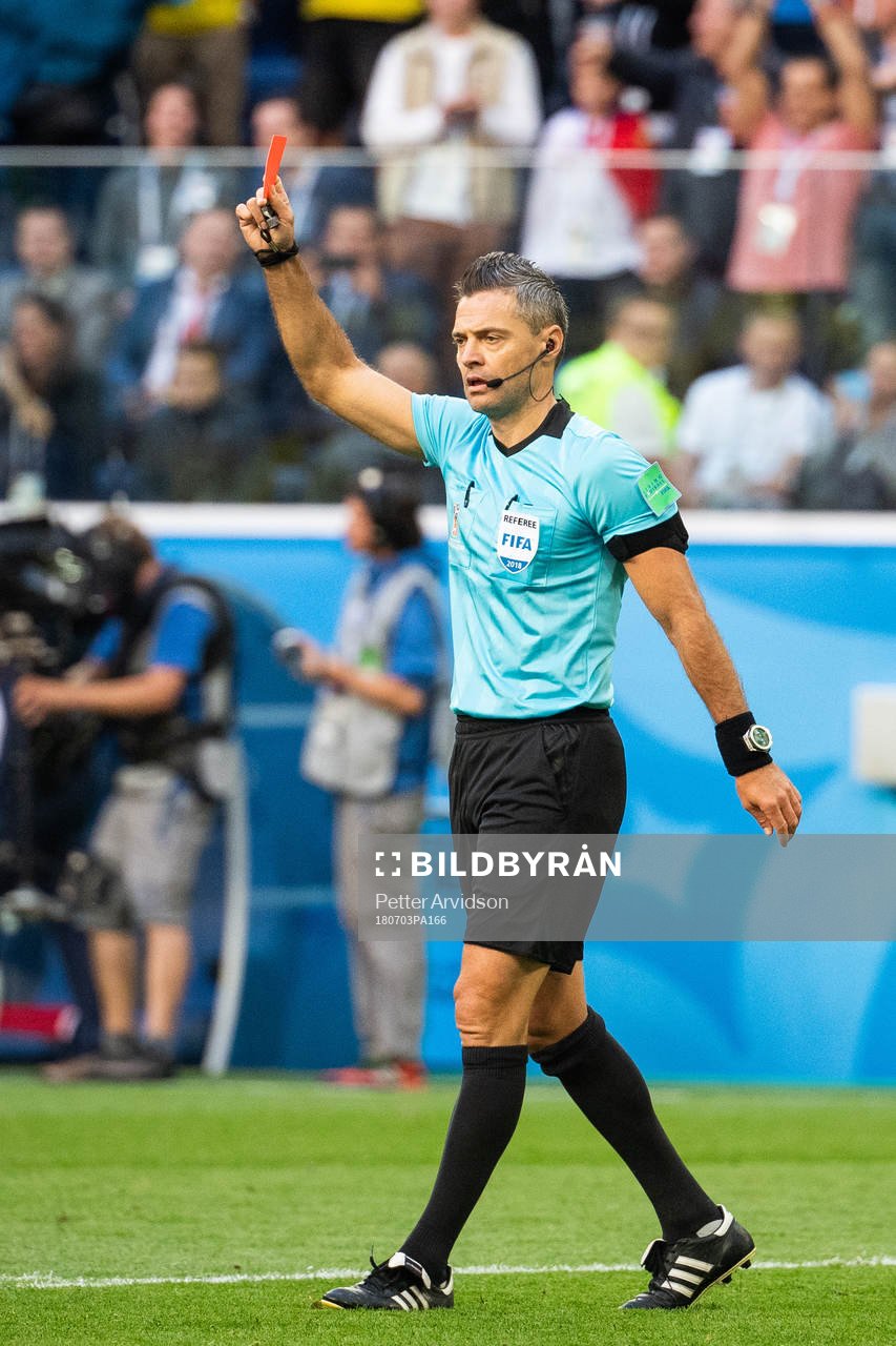 The referee awards Michael Lang of Switzerland with a red card during the FIFA World Cup round of 16 match between Sweden and Switzerland on July 3, 2018 in ST Petersburg.
