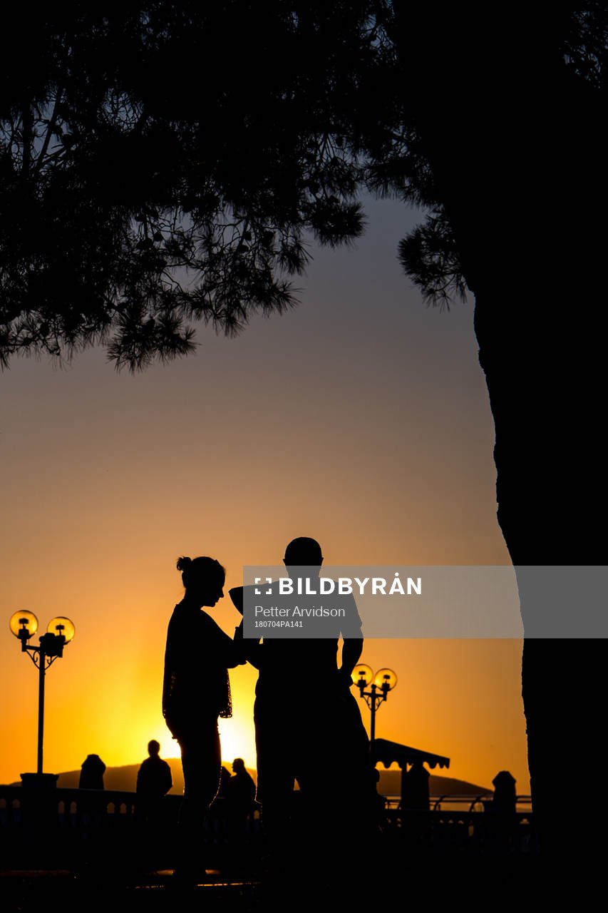 People walks in the sunset