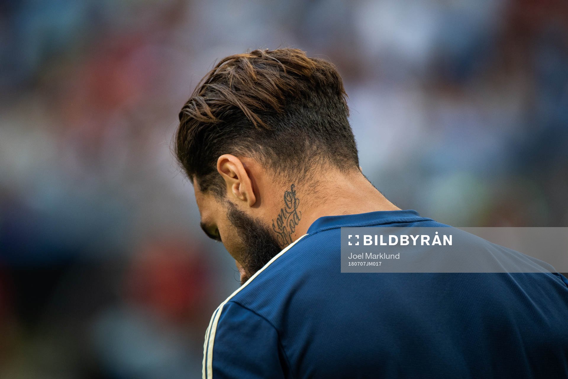 A tattoo with the text son of god seen