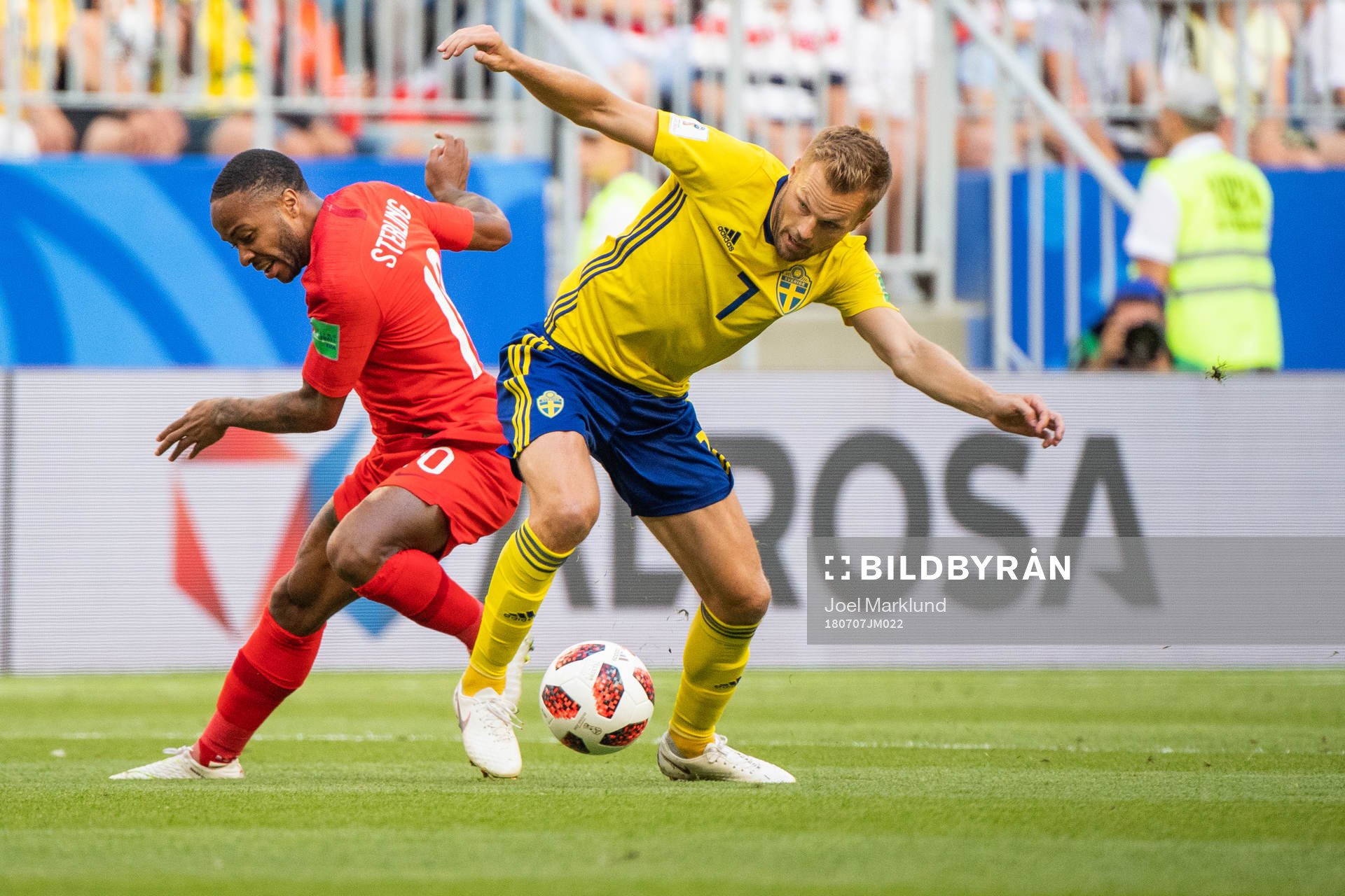 Raheem Sterling of England competes for the ball with