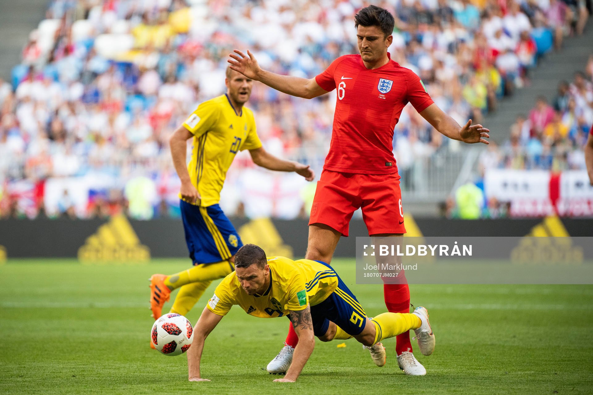 Marcus Berg of Sweden falls in a duel with Harry Maguire of