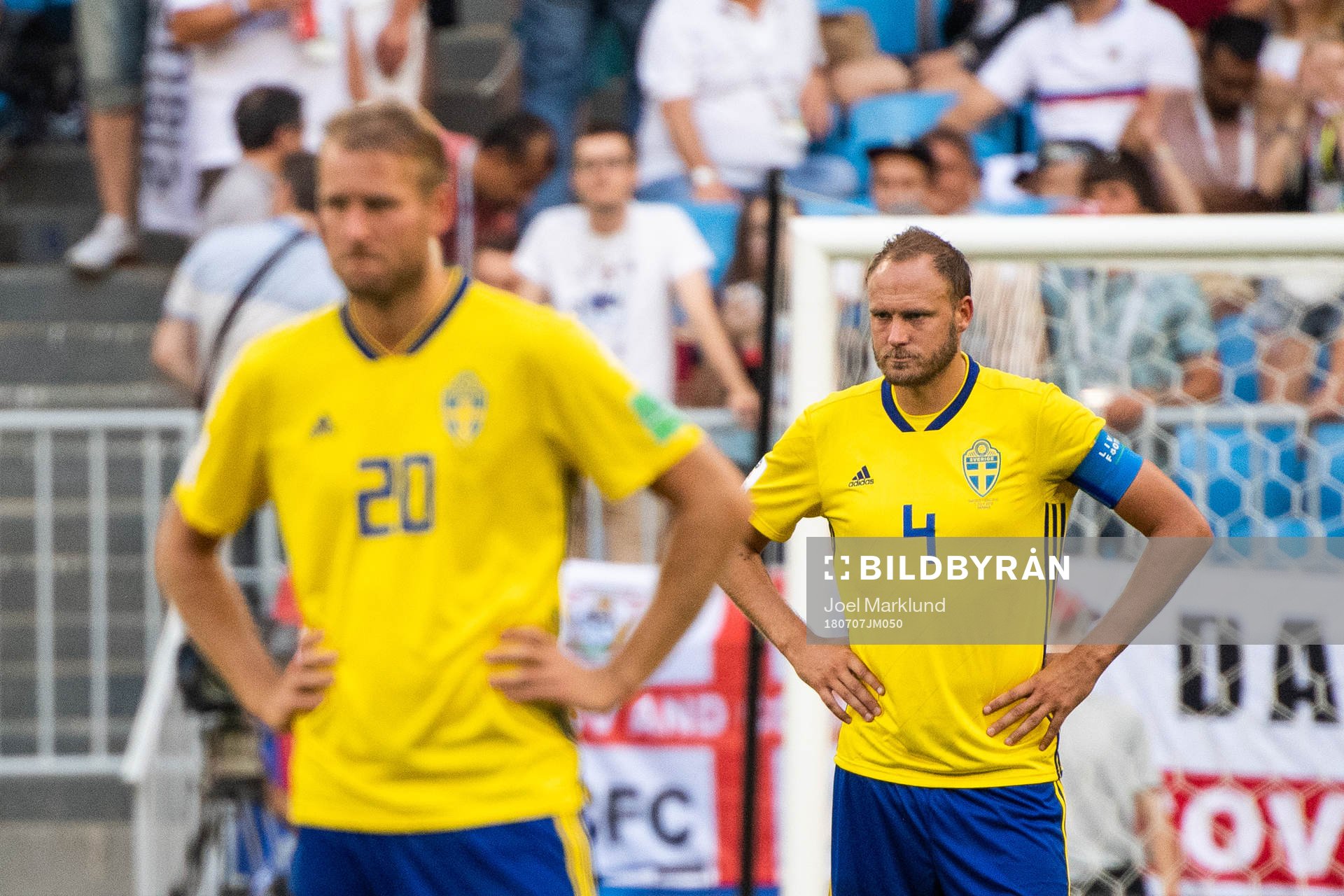 Ola Toivonen and Andreas Granqvist of Sweden looks dejected