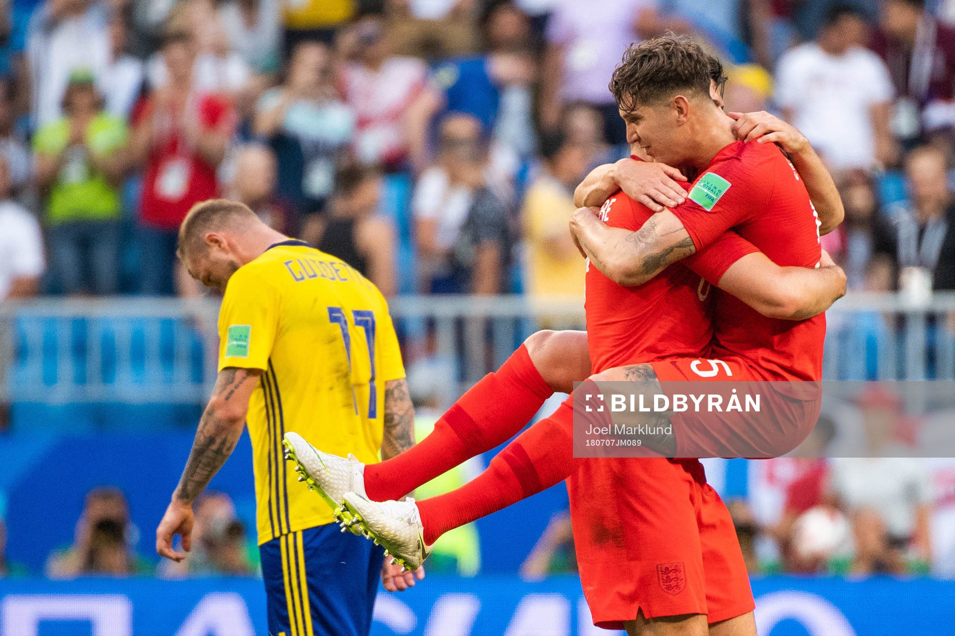 John Guidetti of Sweden looks dejected while John Stones of
