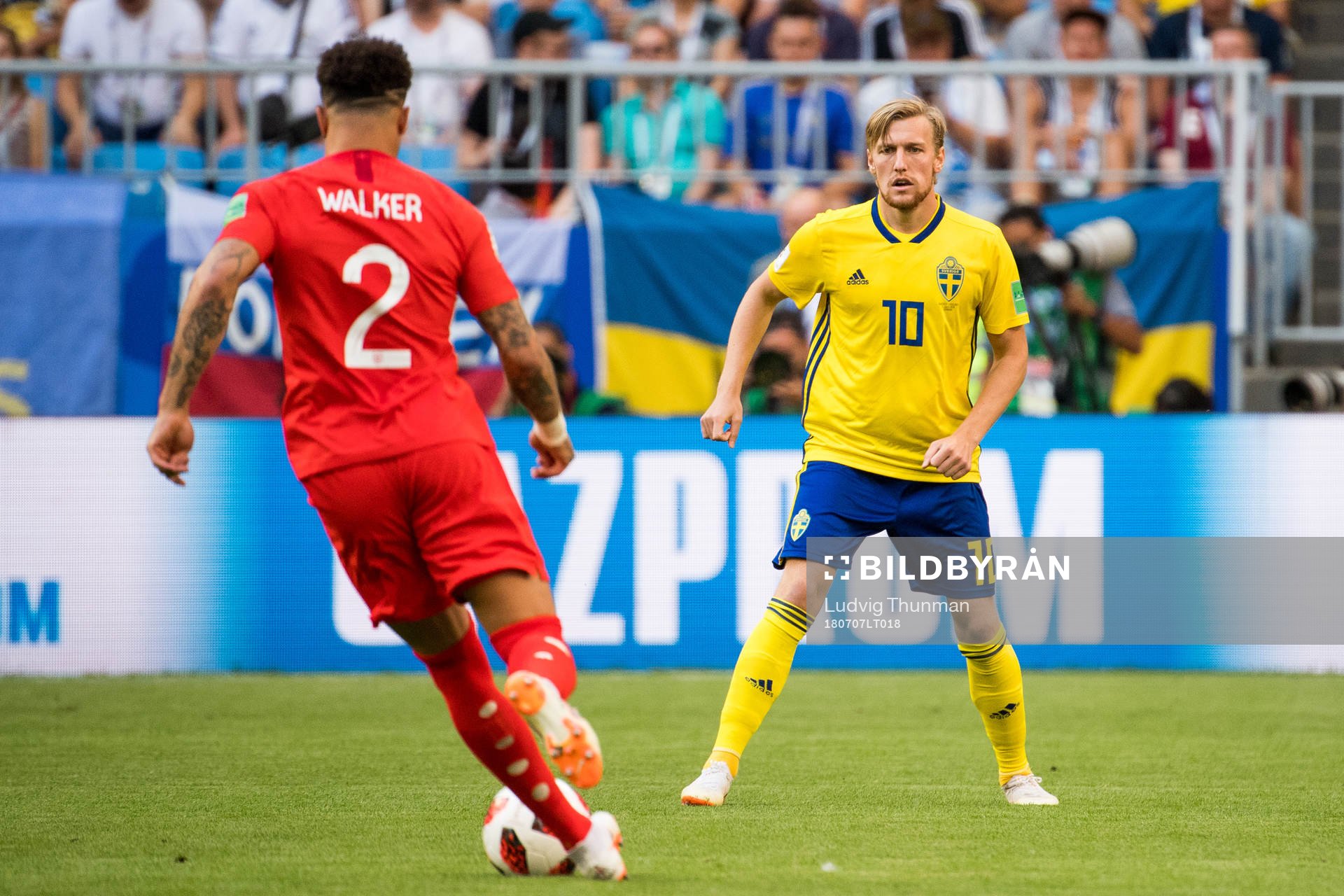 Kyle Walker of England and Emil Forsberg of Sweden