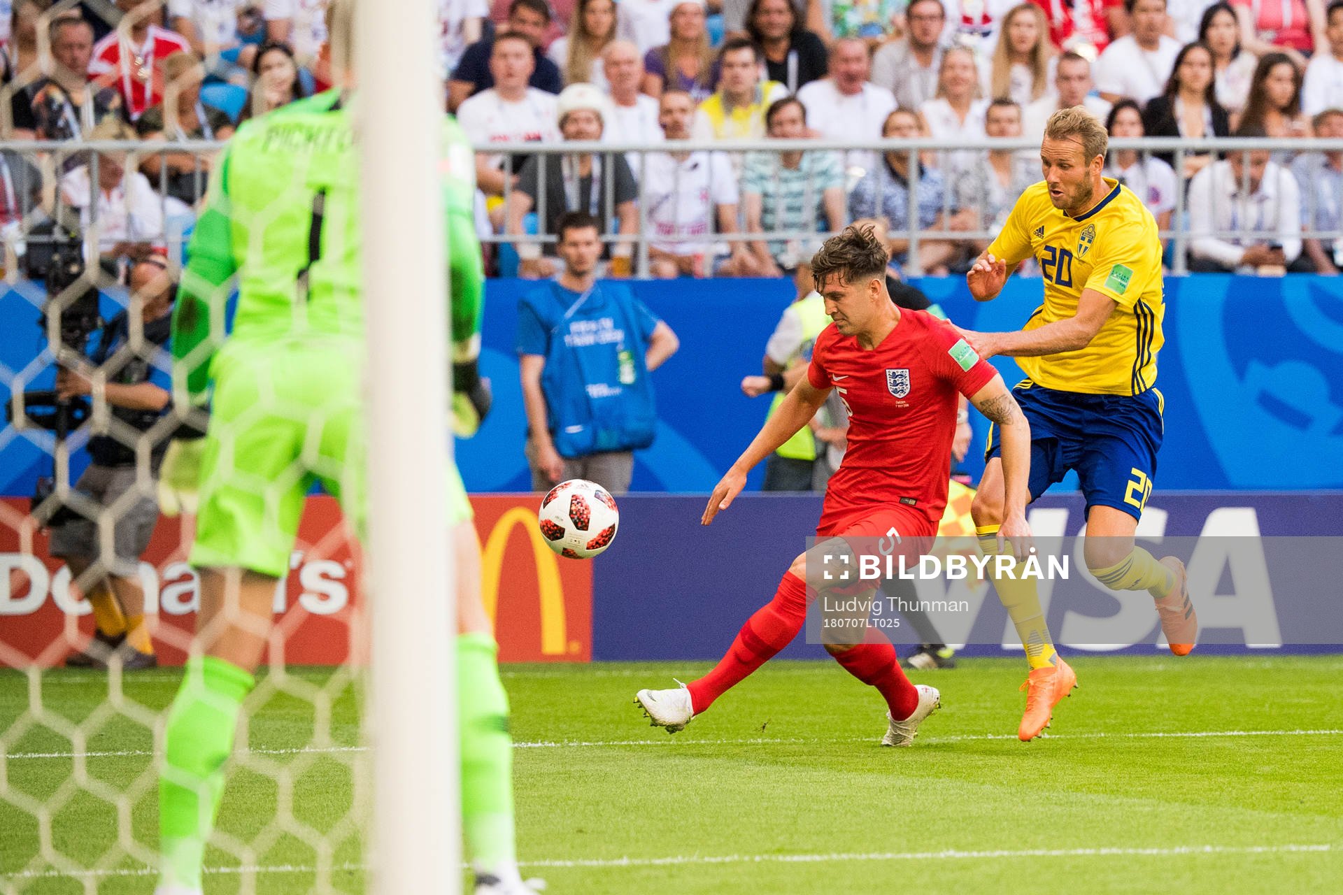 John Stones of England and Ola Toivonen of Sweden