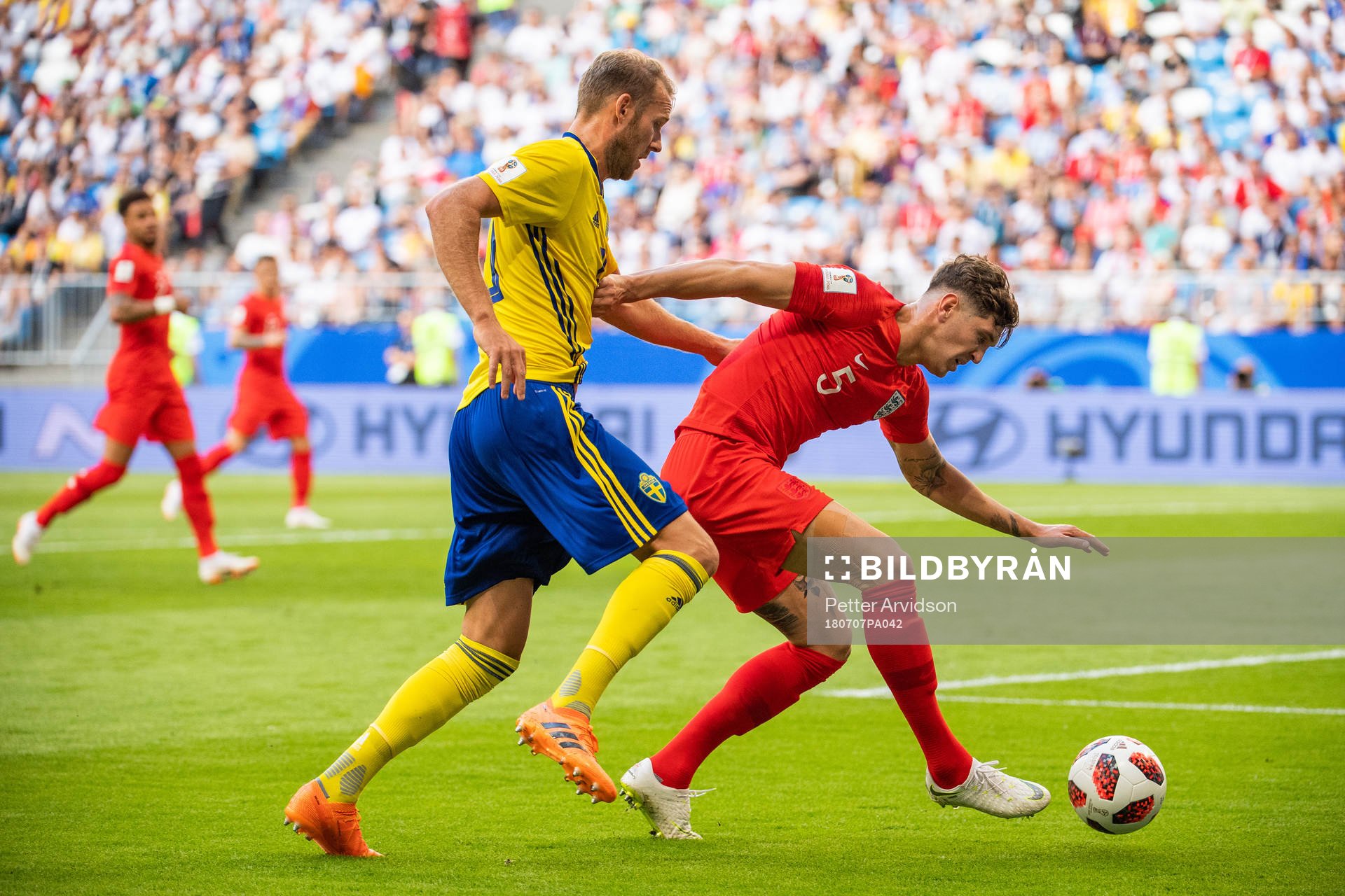 Ola Toivonen of Sweden competes for the ball with John