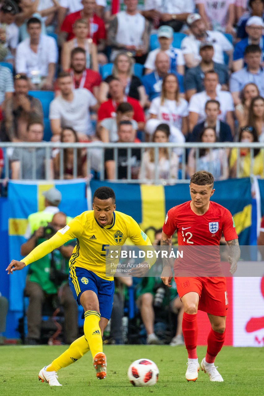 Martin Olsson of Sweden and Kieran Trippier of England