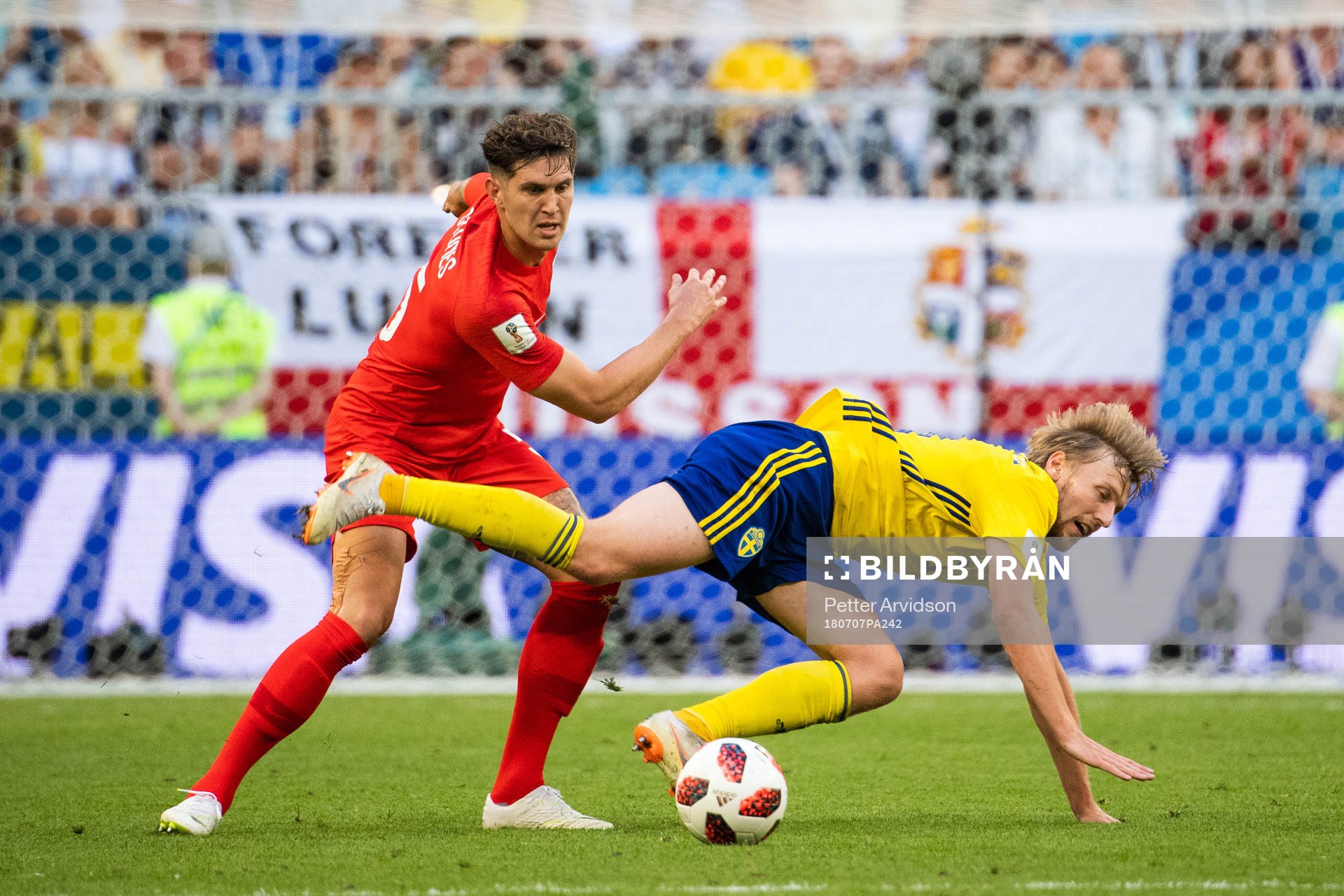 John Stones of England and Emil Forsberg competes for the