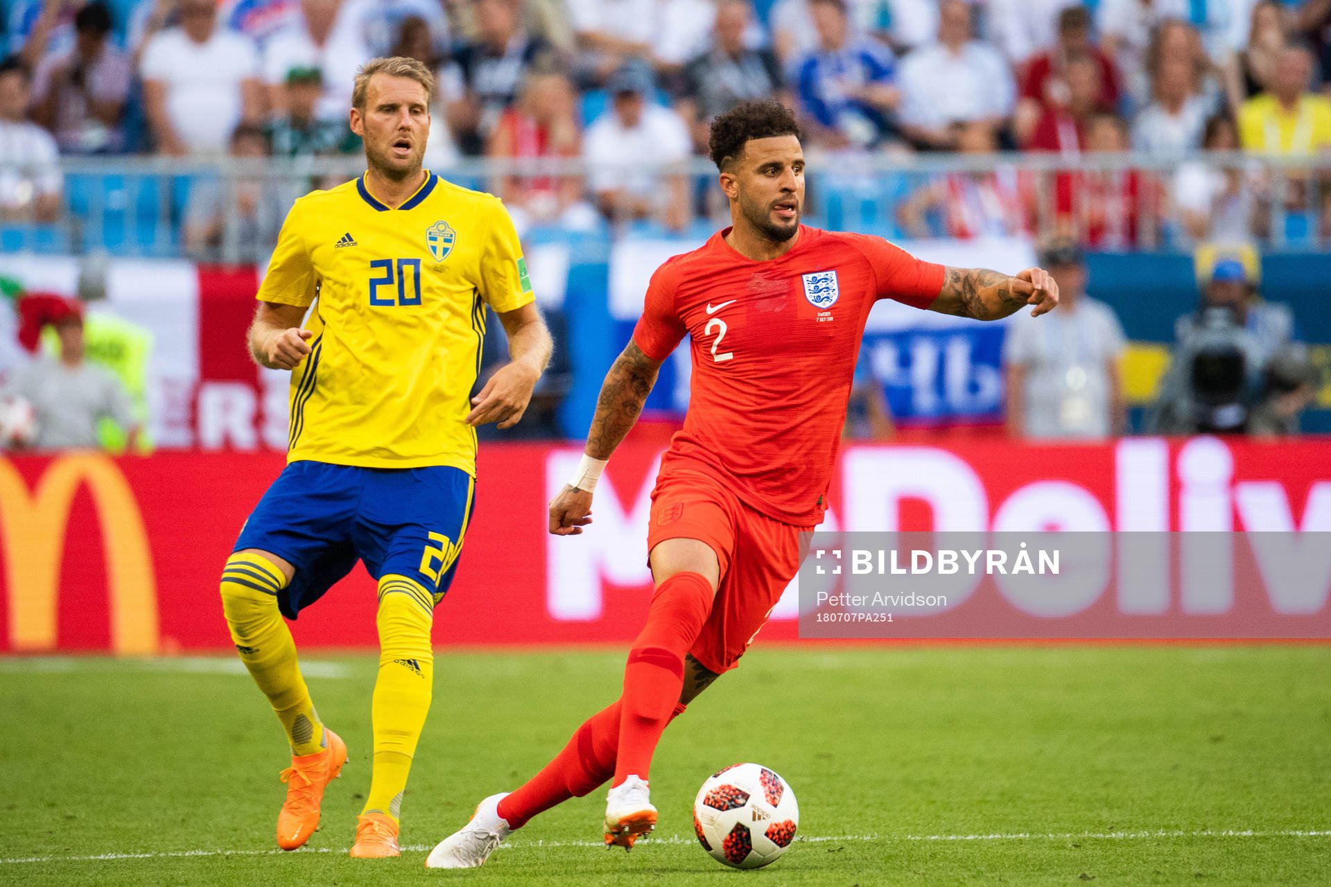 Kyle Walker of England competes for the ball with Ola