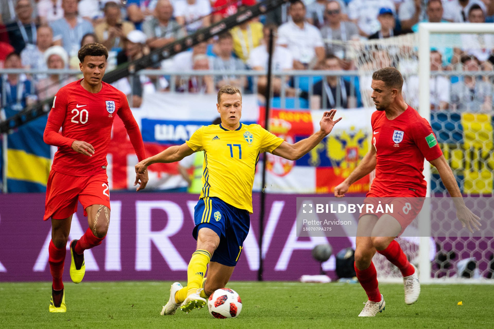 Dele Alli and Jordan Henderson competes for the ball with