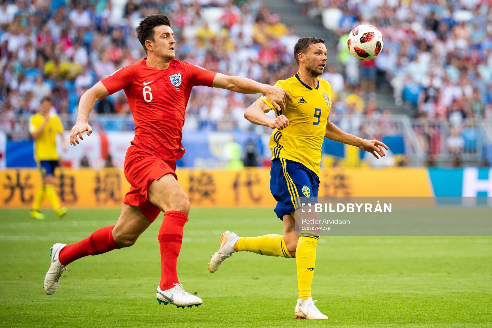 Harry Maguire of England and Marcus Berg of Sweden