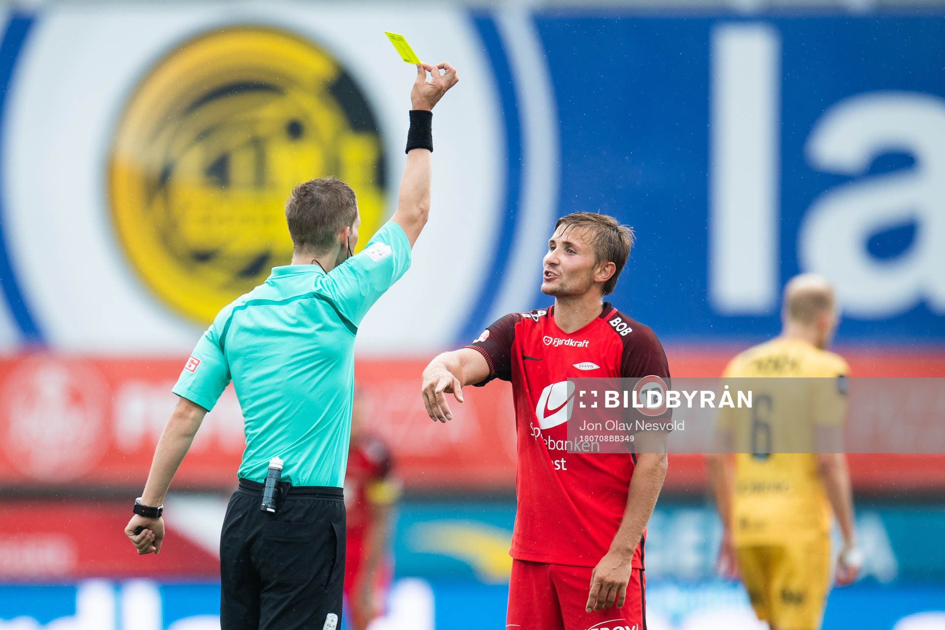 Espen Andreas Eskås, referee, gives a yellow card to