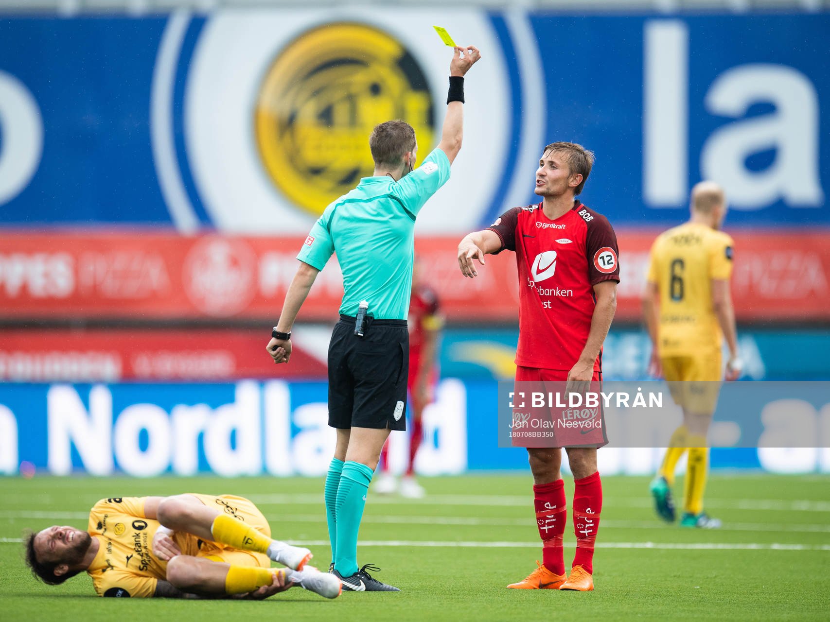 Espen Andreas Eskås, referee, gives a yellow card to