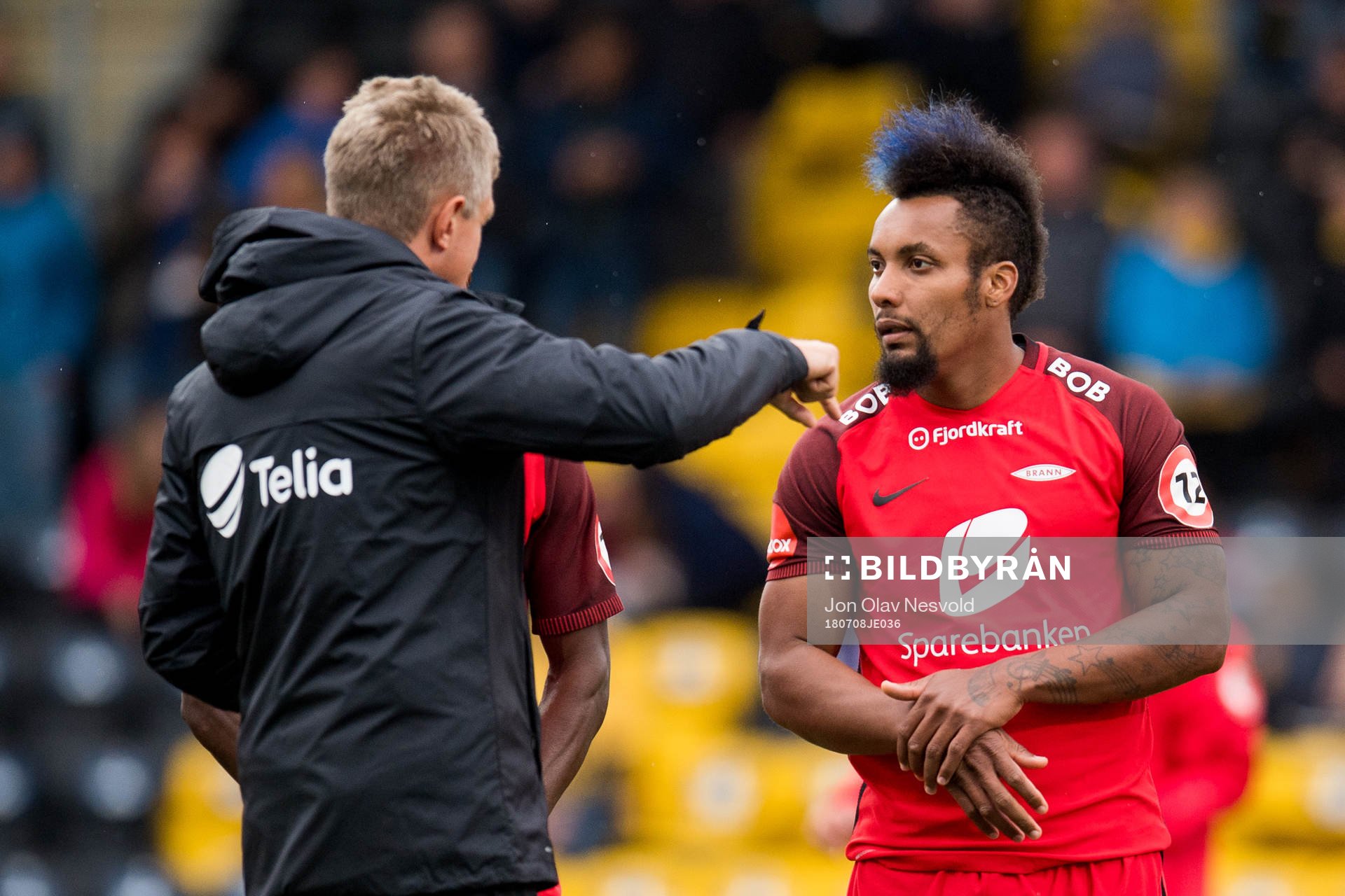 Lars Arne Nilsen, head coach of Brann, gives instructions to Bismar Acosta and Gilli Rolantsson of Brann ahead of the Eliteserien match between Bodø/Glimt and Brann on July 8, 2018 in Bodø.