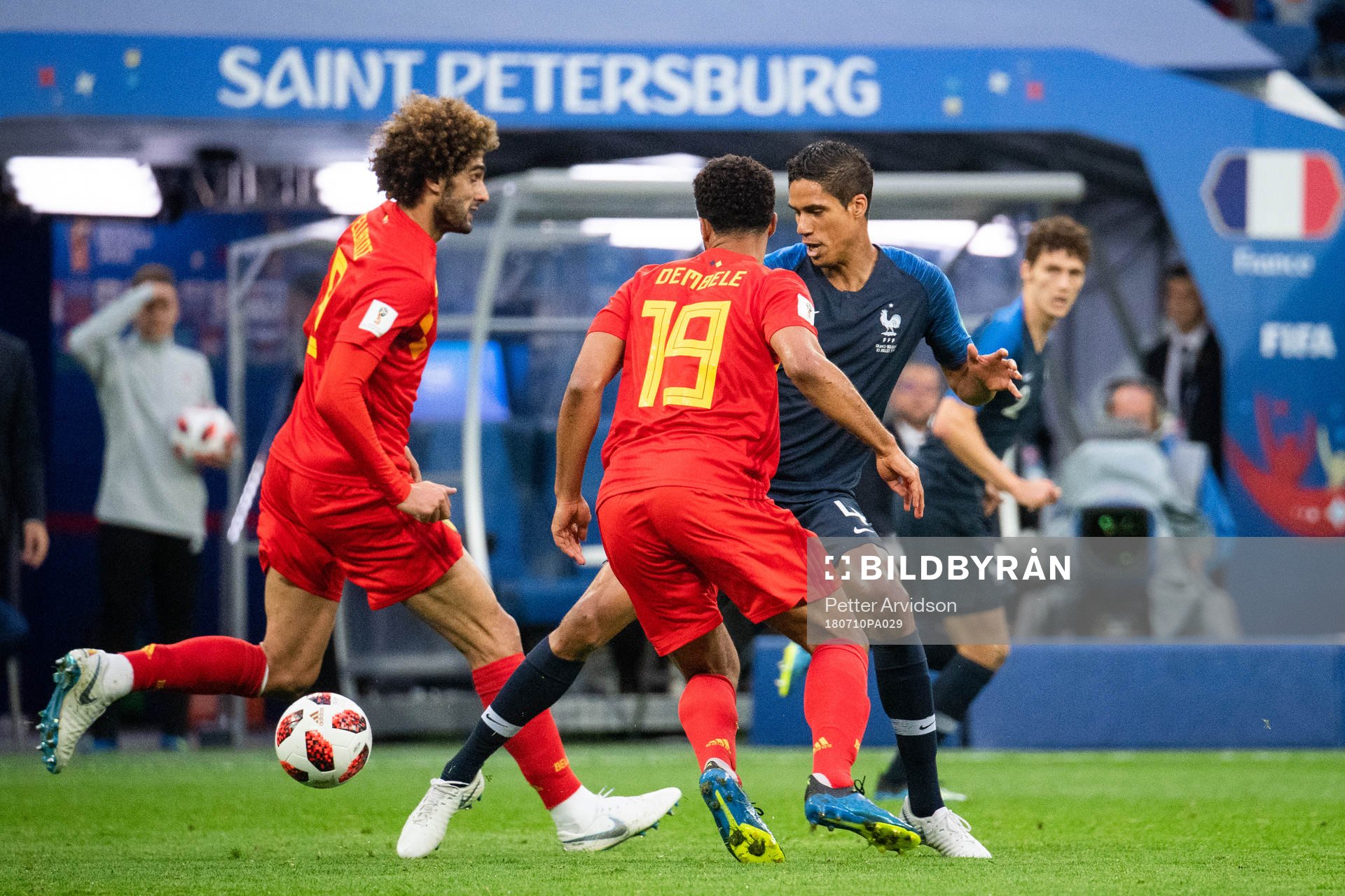 Moussa Dembele and Marouane Fellaini of Belgium competes