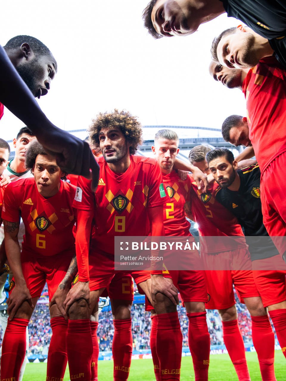Romelu Lukaku talks to team mates Axel Witsel, Marouane