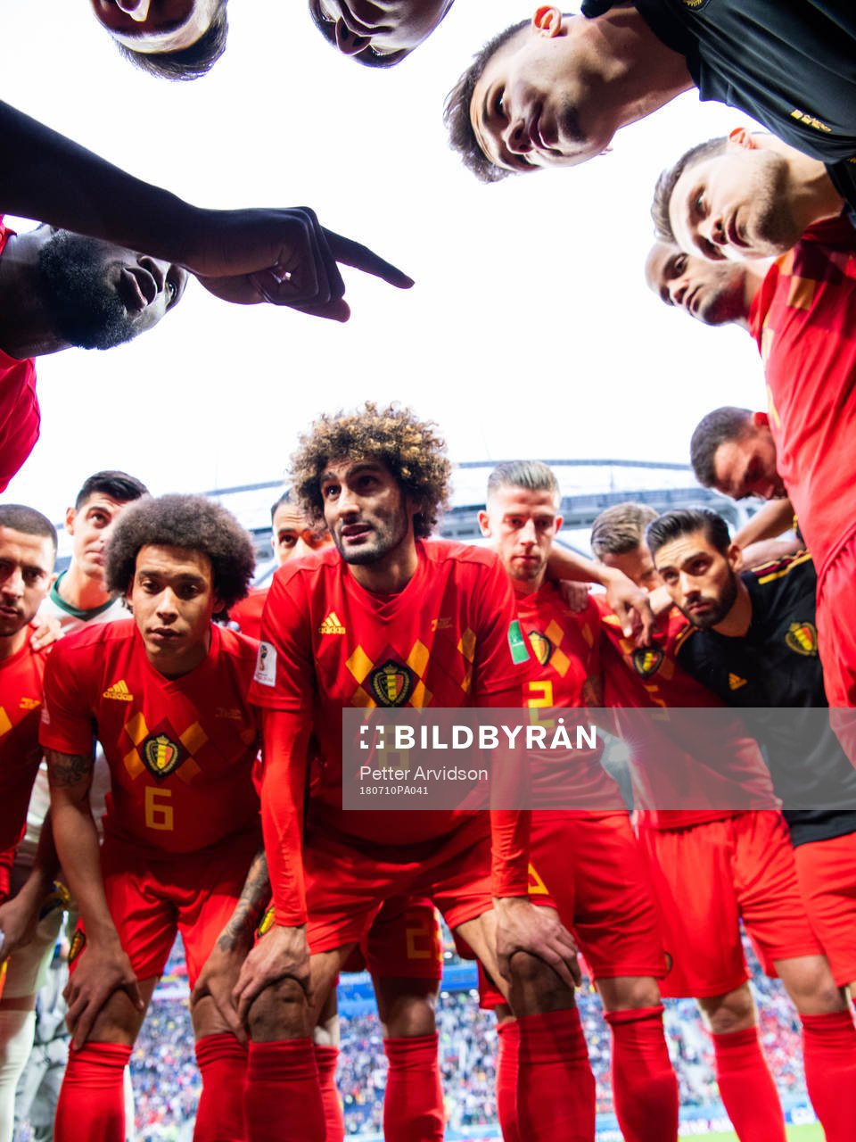 Romelu Lukaku talks to team mates Axel Witsel, Marouane