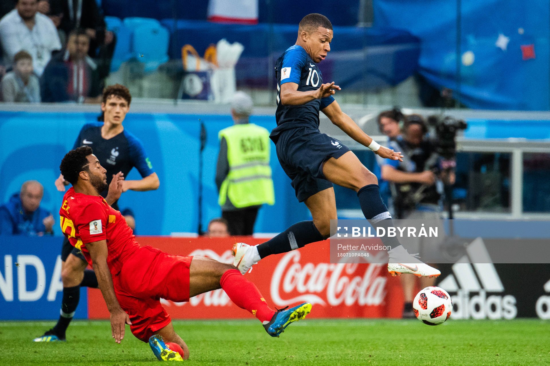 Dedryck Boyata of Belgium tackles Kylian Mbappe of France