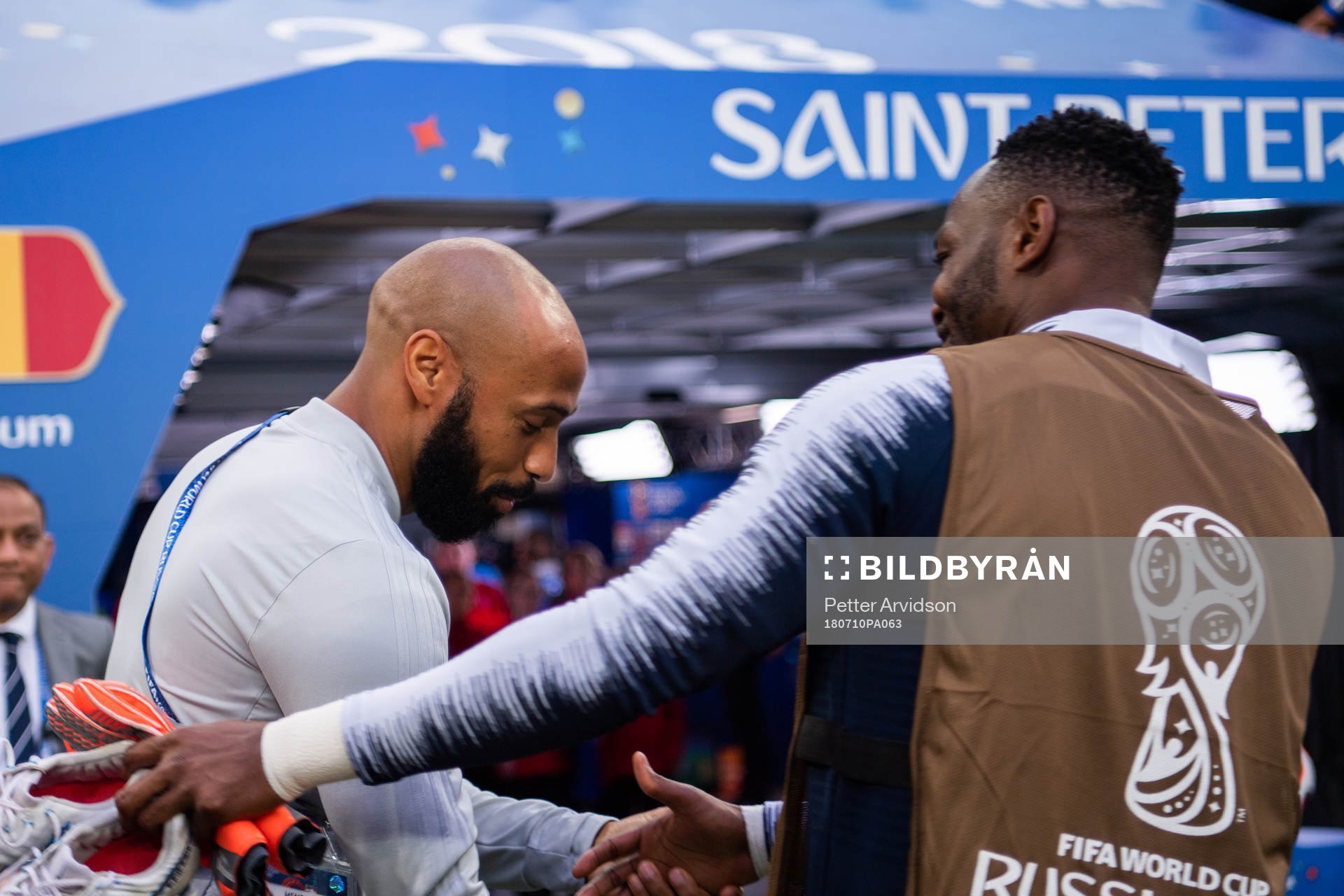 Assisting coach Thierry Henry of Belgium hugs a french