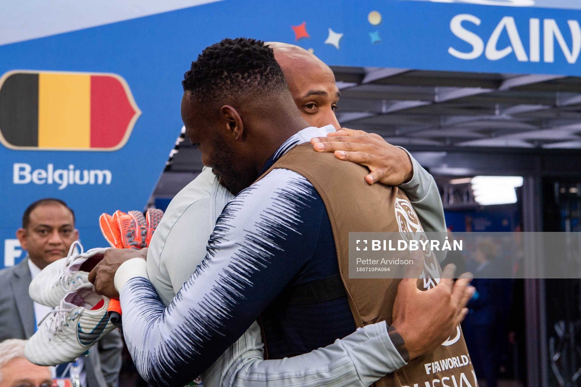 Assisting coach Thierry Henry of Belgium hugs a french